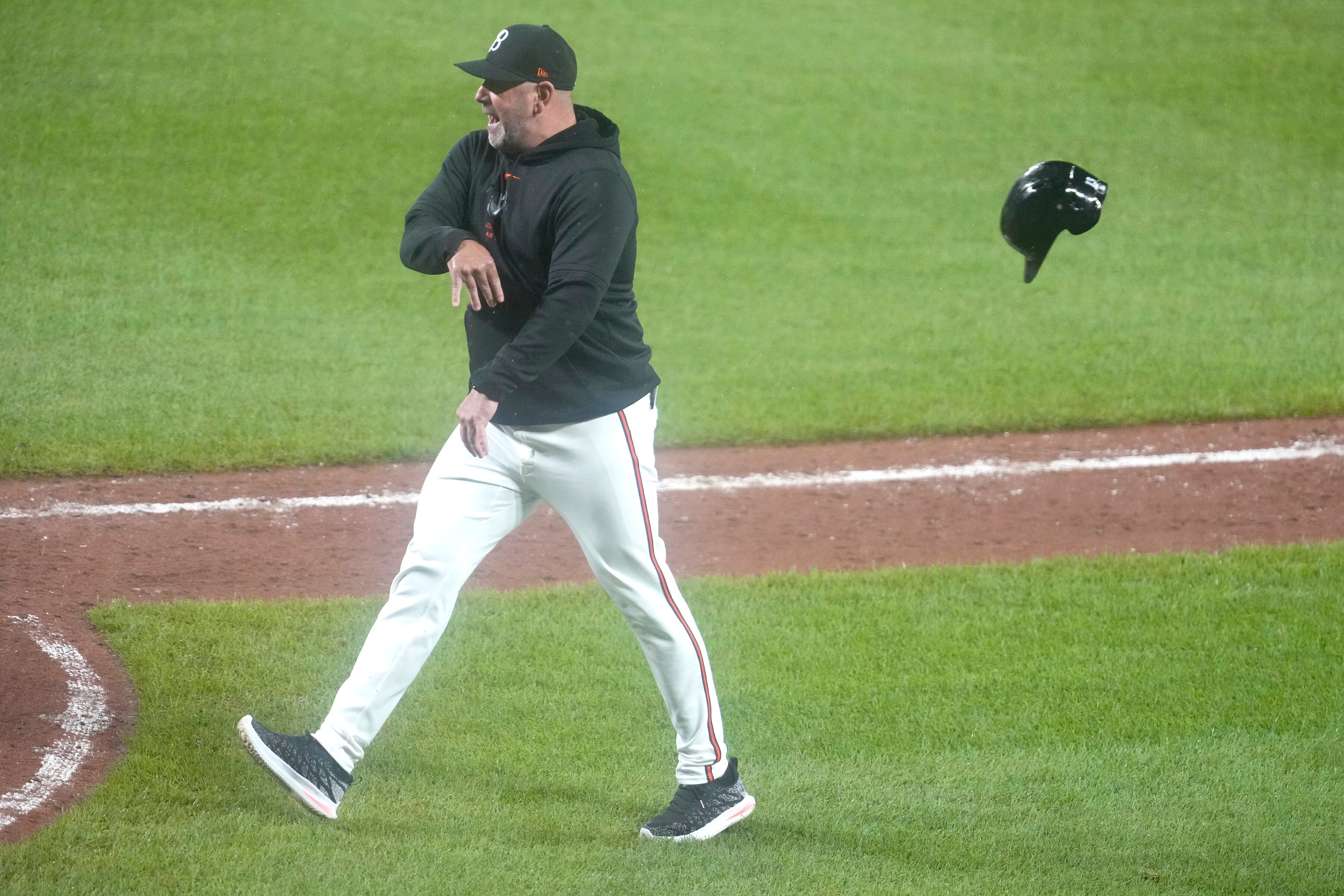 BALTIMORE, MD - JULY 12:  Manager Brandon Hyde #18 of the Baltimore Orioles throws a helmet after Heston Kjerstad #13 of the Baltimore Orioles was hit by a ball in the ninth inning during a baseball game between the New York Yankees and the Baltimore Orioles at the Oriole Park at Camden Yards on July 12, 2024 in Baltimore, Maryland.  (Photo by Mitchell Layton/Getty Images)