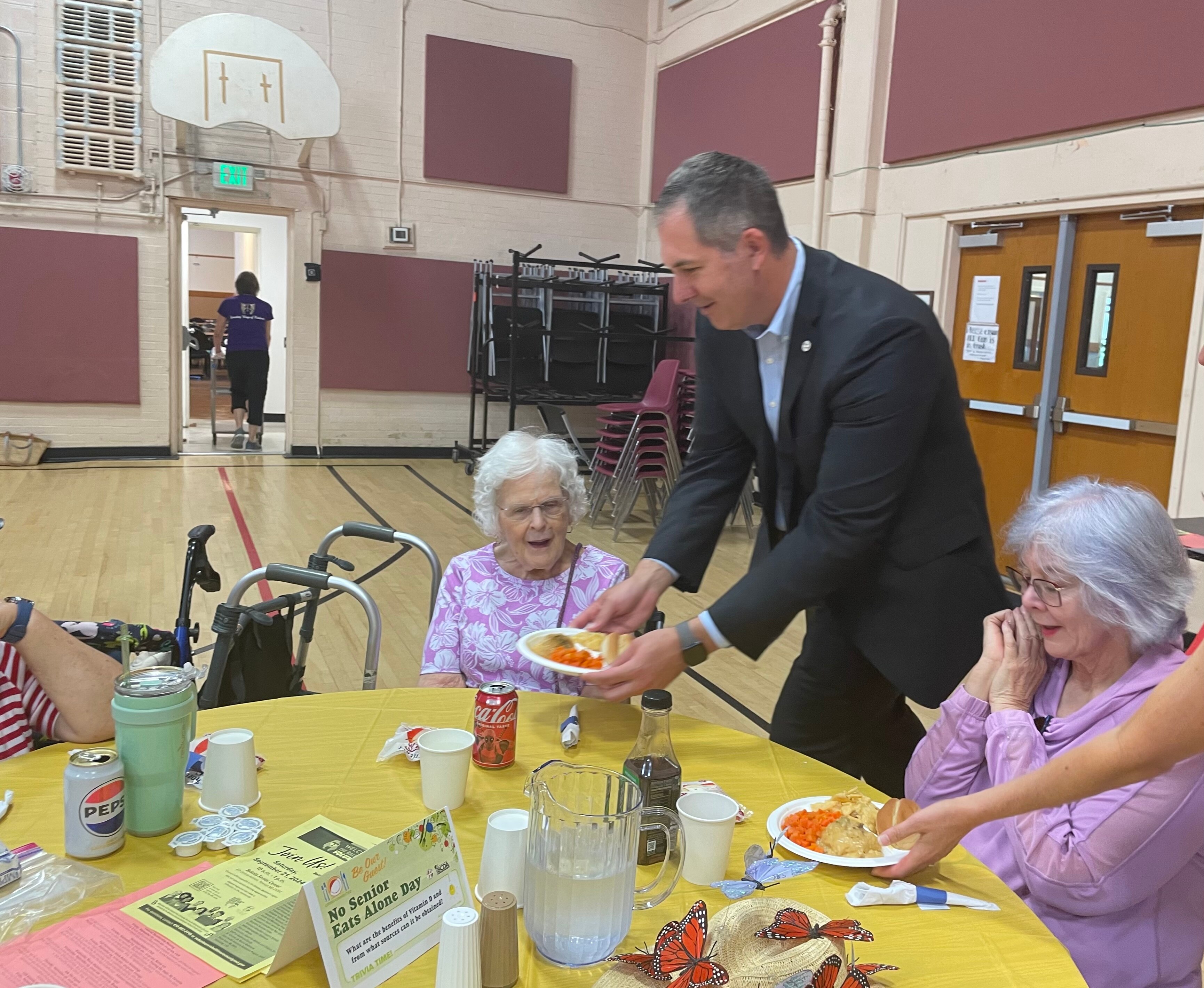 Baltimore County Executive Johnny Olszewski Jr. serving meals in Towson.