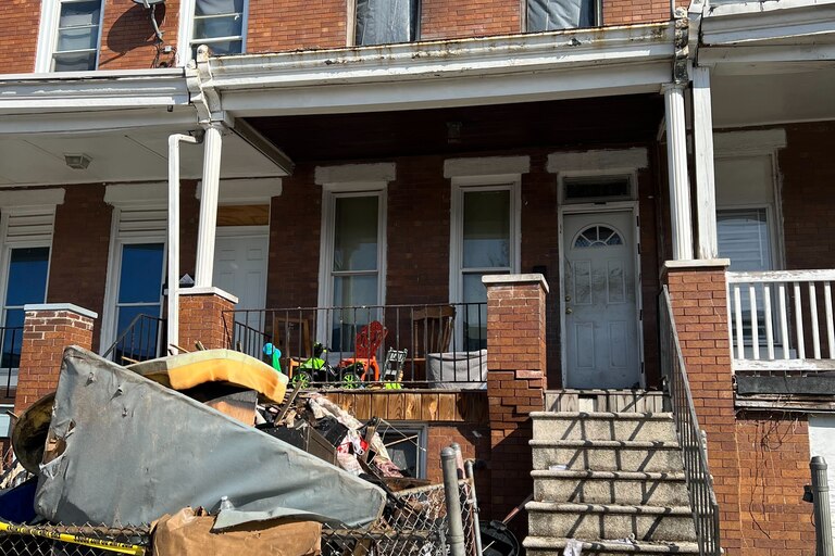 Three children died and two adults were critically injured in an early-morning house fire in West Baltimore. Burned belongings are piled up outside the home in the 3000 block of Brighton Street.