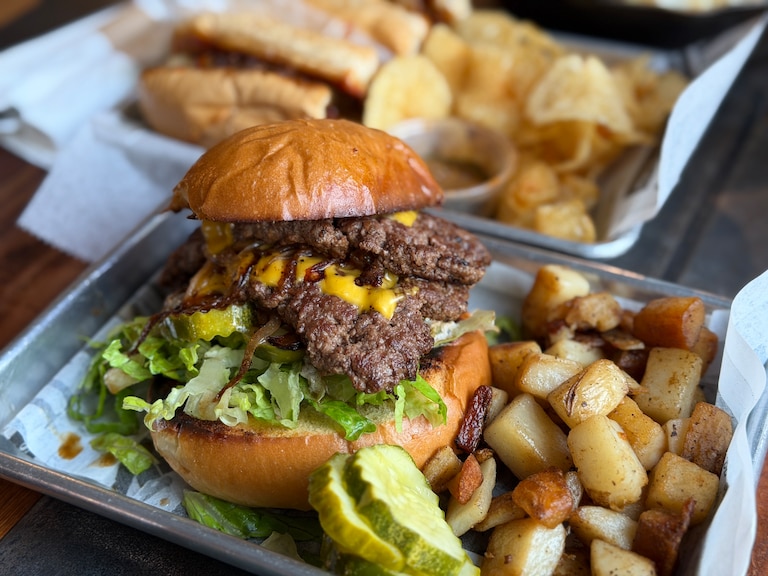 Chuck's Trading Post uses smoked garlic-onion aioli for its smashburgers, which come on brioche buns.