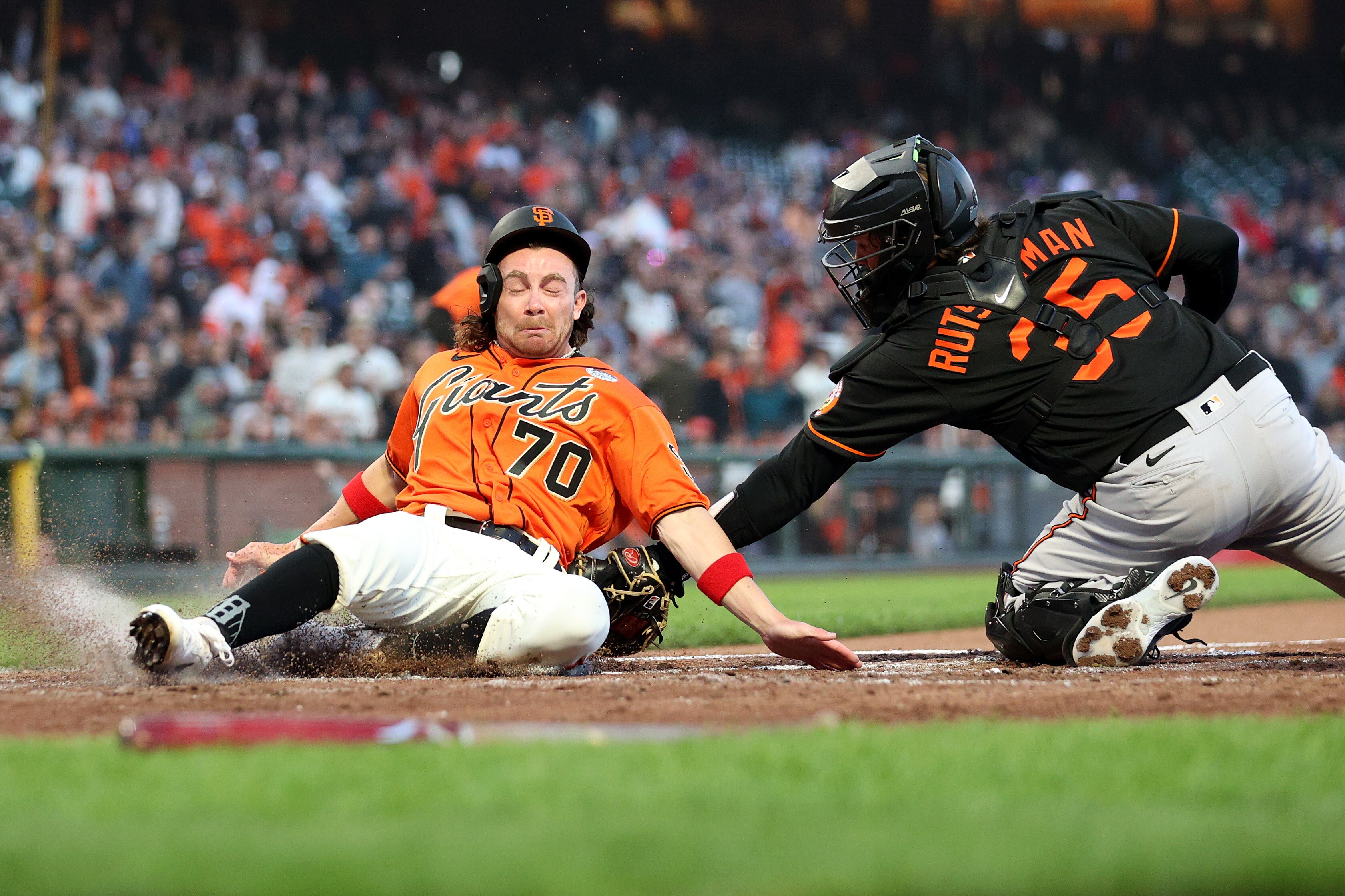 SAN FRANCISCO, CALIFORNIA - JUNE 02: Brett Wisely #70 of the San Francisco Giants is tagged out by Adley Rutschman #35 of the Baltimore Orioles in the third inning on June 02, 2023 in San Francisco, California.