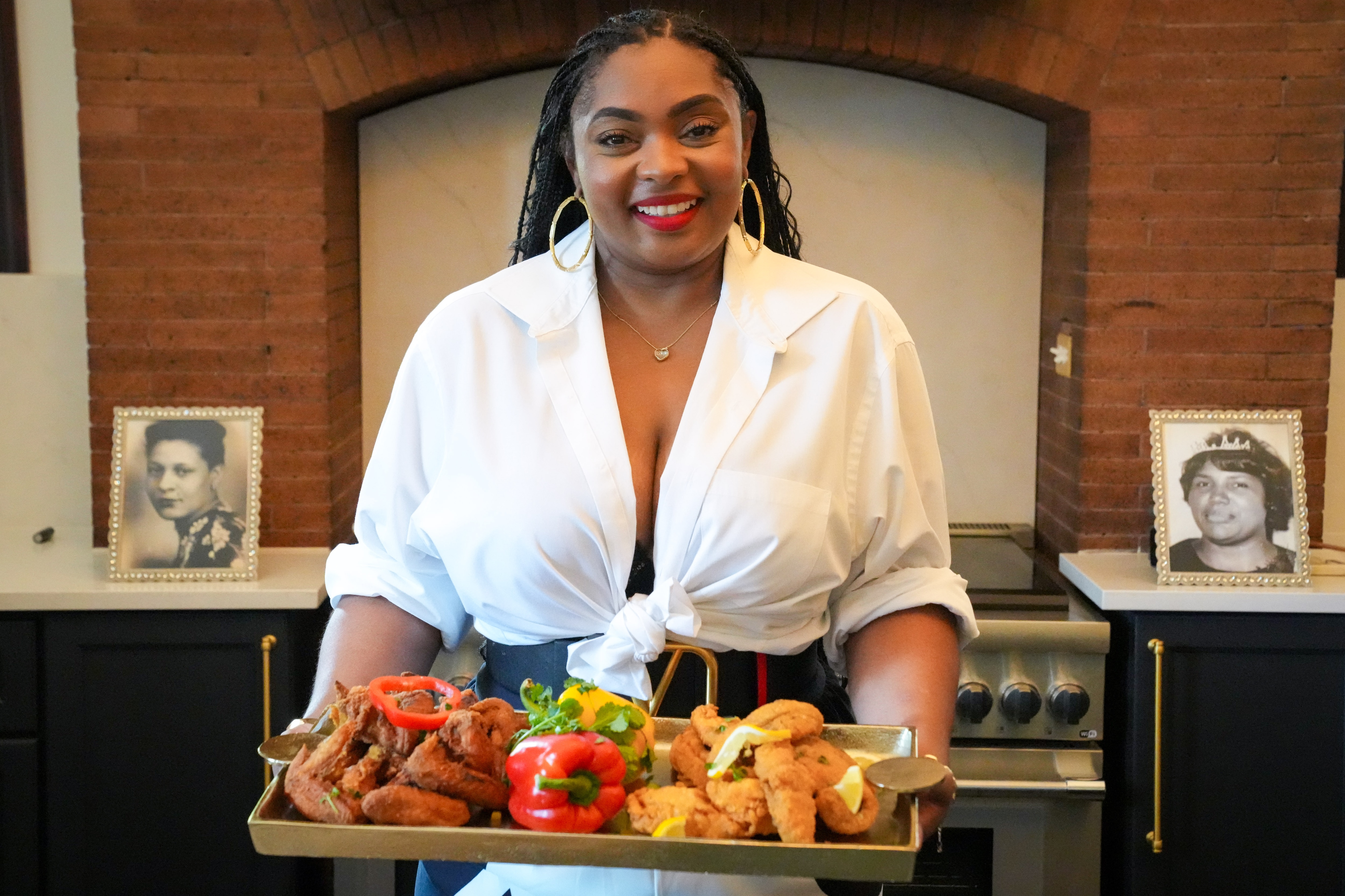 Katie-Marie Fickling, executive chef at Capital Lounge, poses with a spread of some of her dishes.