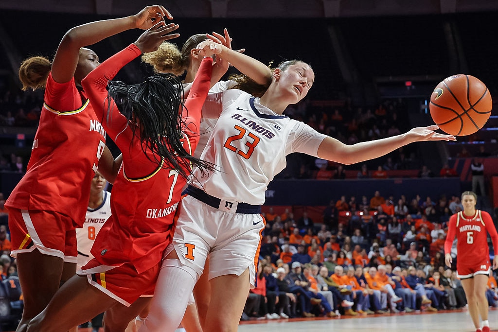 Berry Wallace #23 of the Illinois Fighting Illini reaches for the ball against Oluchi Okananwa #7 of the Maryland Terrapins during the first half.