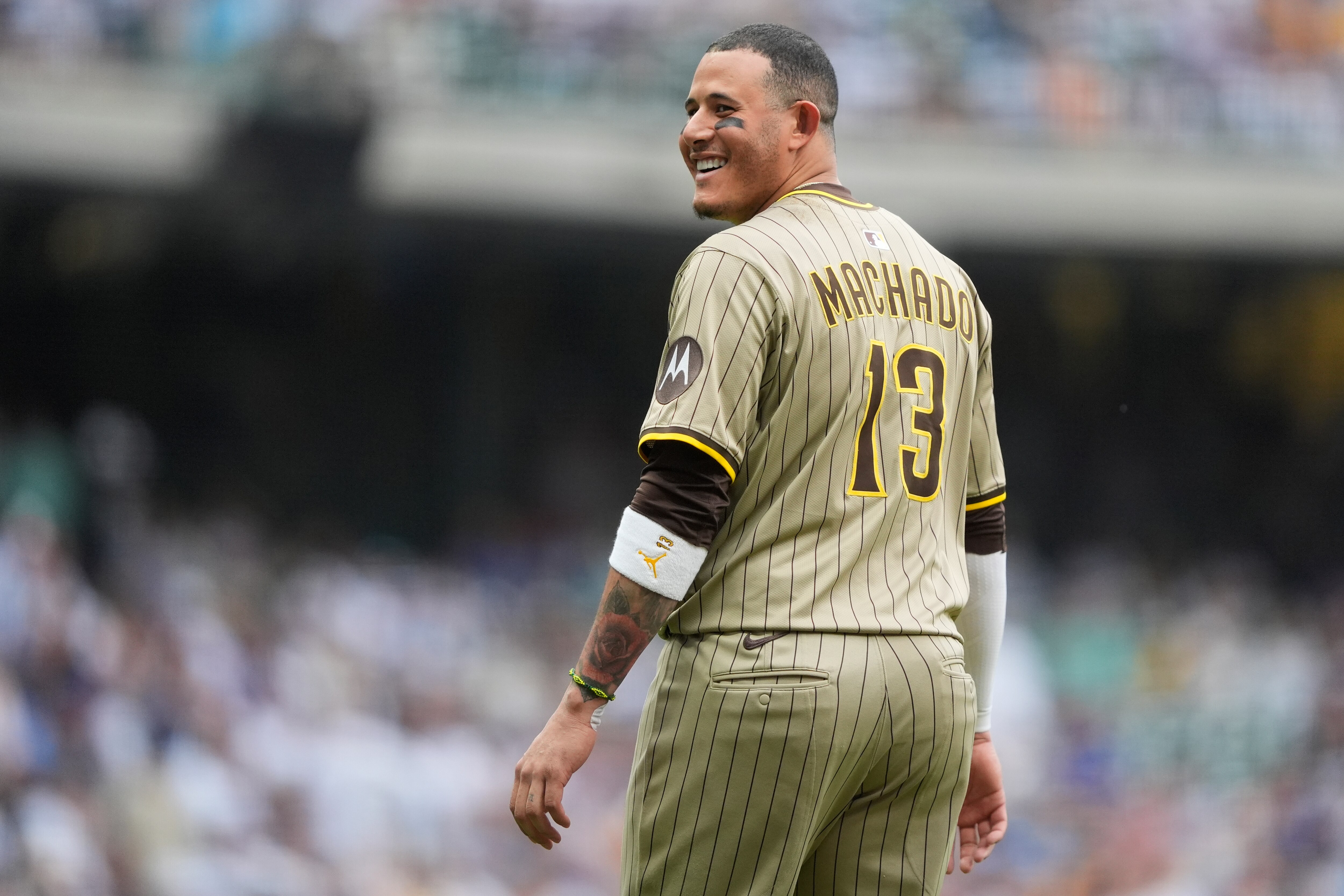 San Diego Padres' Manny Machado laughs during a baseball game against the Milwaukee Brewers, Saturday, June 7, 2025, in Milwaukee.