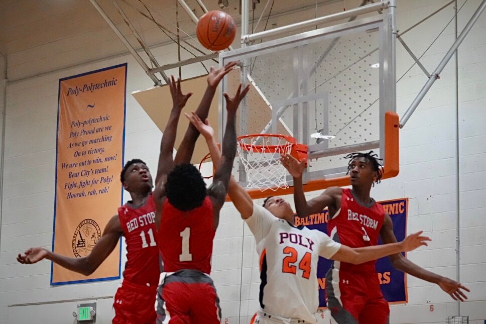 Edmondson and Poly players try to recover a lose ball in the 4th quarter. Edmondson plays Poly boys basketball on 1/27/23.