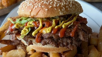 The Royal Blue's smashburger comes with bacon and the option to add a runny egg for brunch.