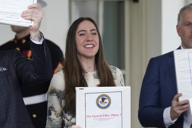 Conservative political commentator Rogan O'Handley, also known as DC Draino, from left, and social media content creator Chaya Raichik, hold up binders with a cover titled "The Epstein Files: Phase 1" at the White House, Thursday, Feb. 27, 2025, in Washington. (AP Photo/Ben Curtis)
