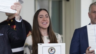 Conservative political commentator Rogan O'Handley, also known as DC Draino, from left, and social media content creator Chaya Raichik, hold up binders with a cover titled "The Epstein Files: Phase 1" at the White House, Thursday, Feb. 27, 2025, in Washington. (AP Photo/Ben Curtis)
