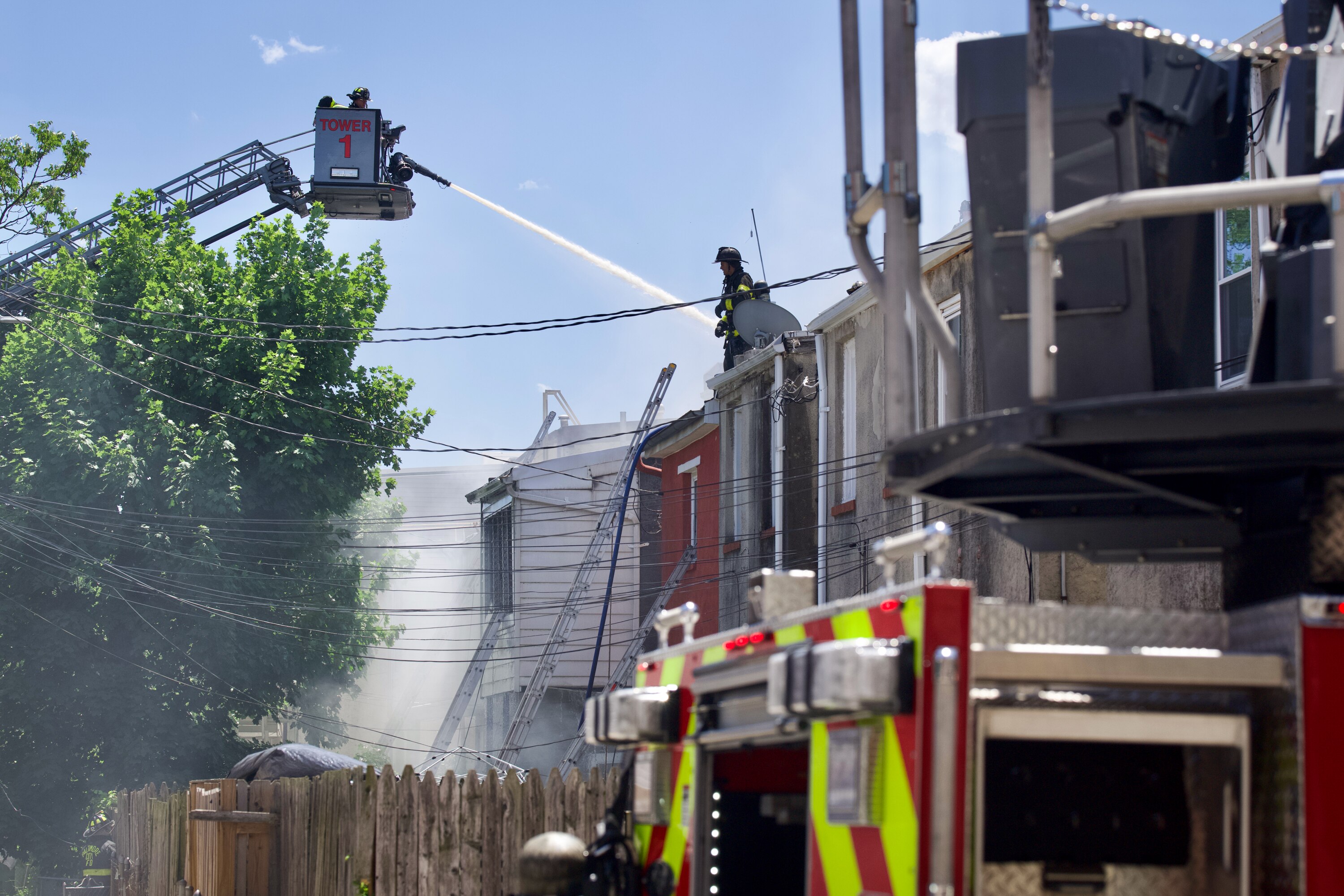 Baltimore City Fire responds to a three-alarm fire that erupted through upper levels of rowhomes in the Barclay neighborhood of Baltimore on Thursday afternoon.