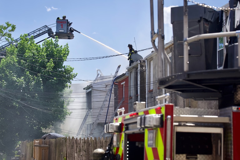Baltimore City Fire responds to a three-alarm fire that erupted through upper levels of rowhomes in the Barclay neighborhood of Baltimore on Thursday afternoon.