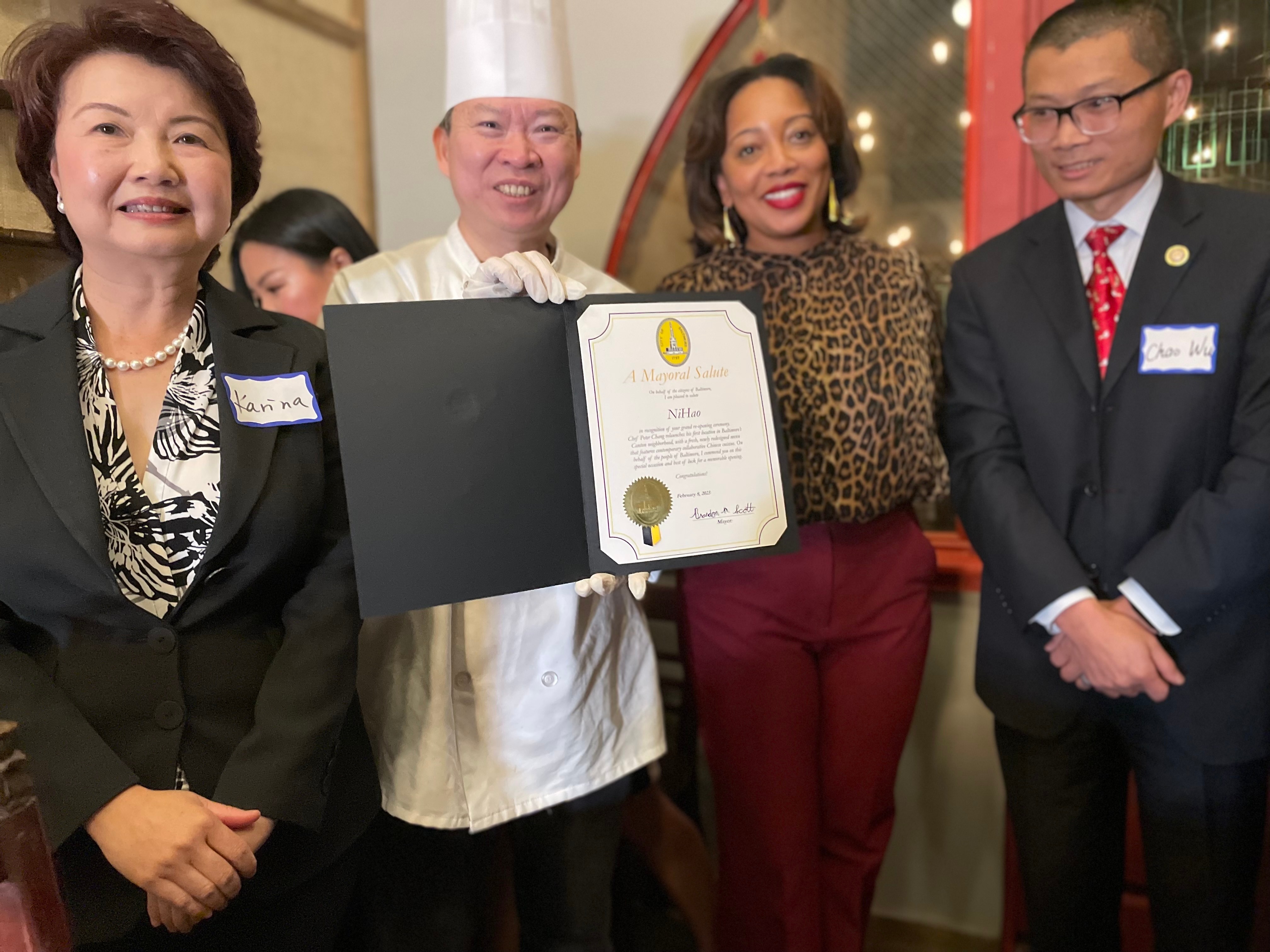 Chef Peter Chang receives a citation signed by Baltimore Mayor Brandon Scott at the Feb. 8 reopening of NiHao, his restaurant in the city's Canton neighborhood.