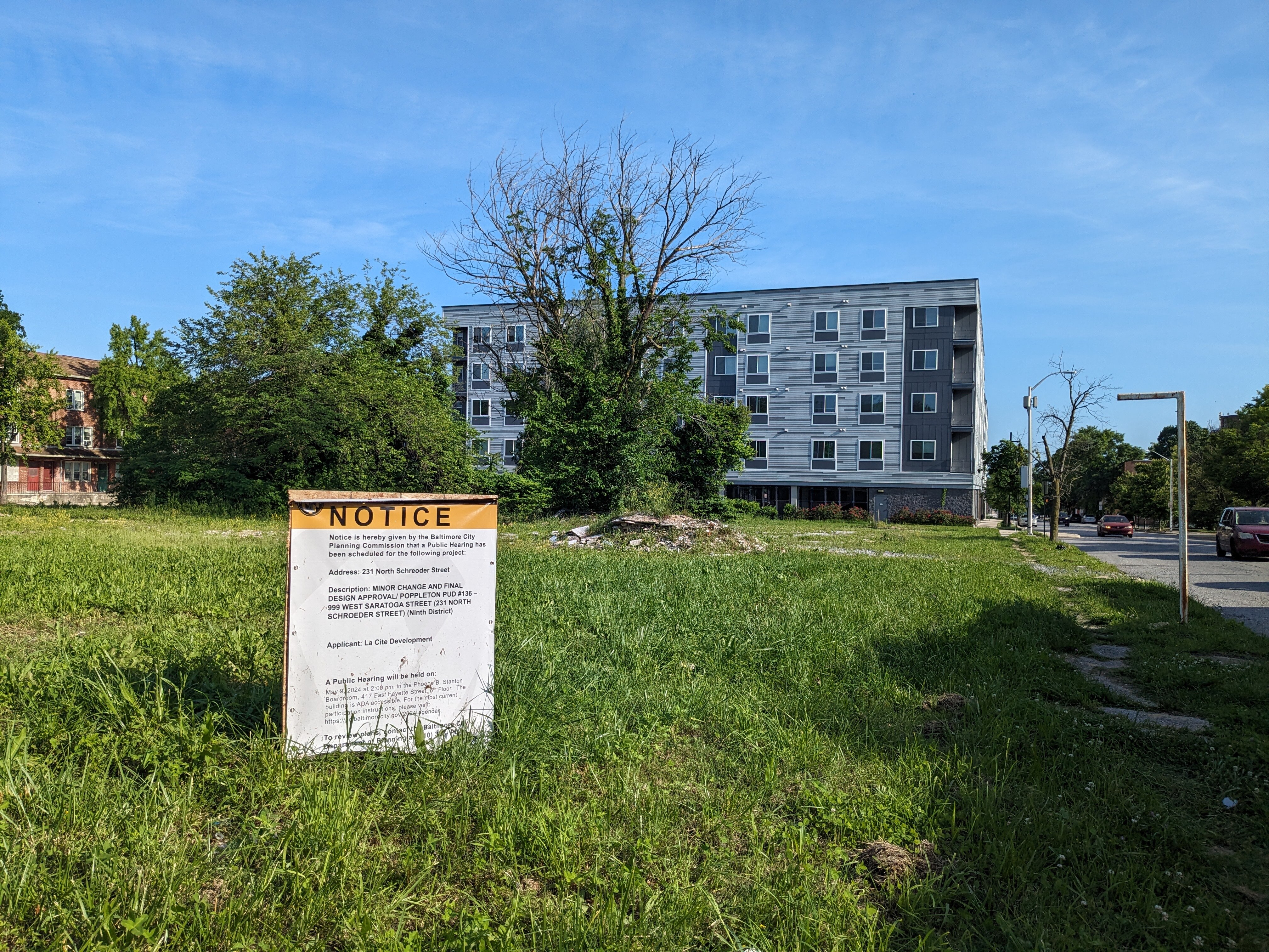This is a photo of an empty lot where a developer wants to build an age-restricted apartment complex.