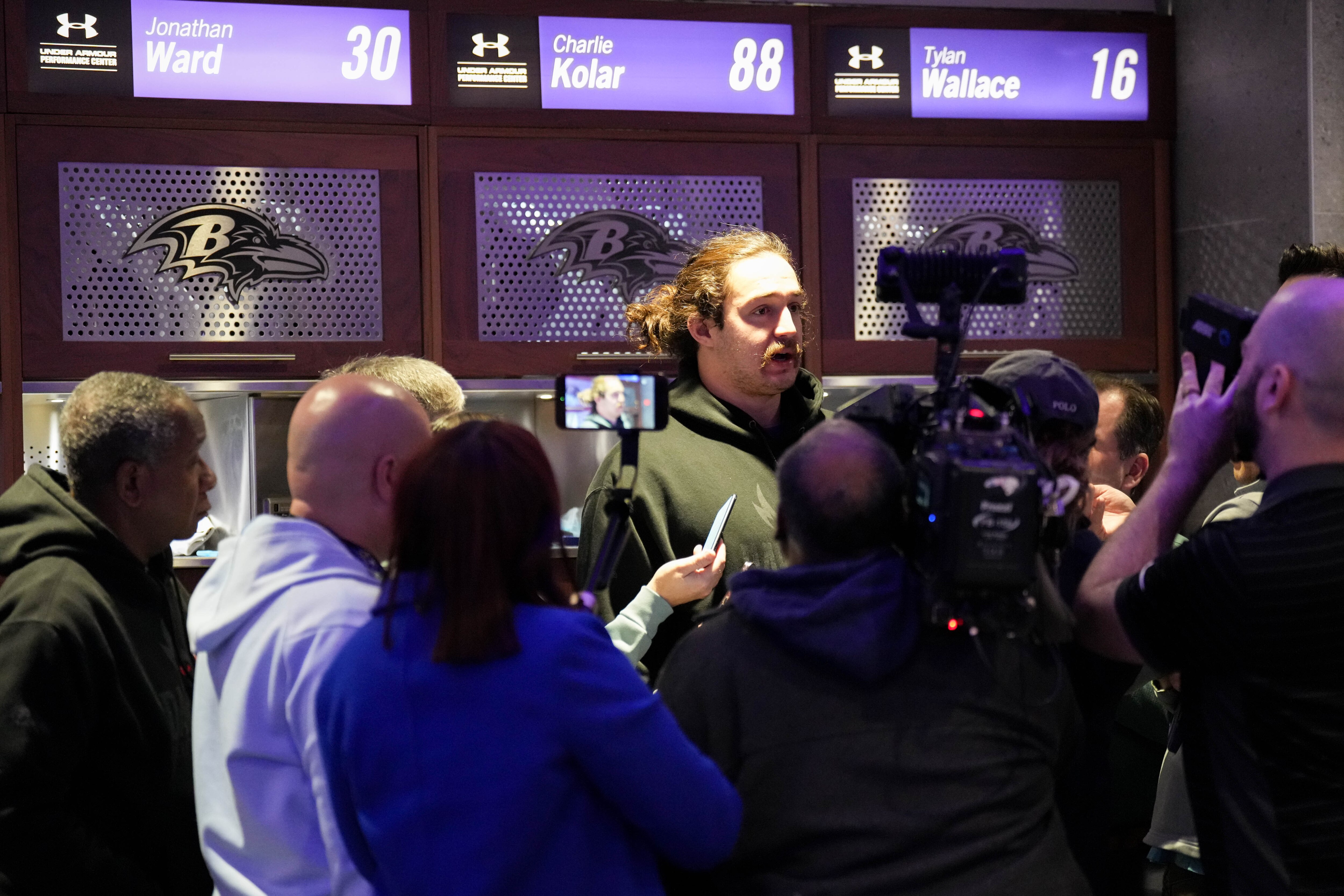 Baltimore Ravens tight end Charlie Kolar is interviewed in a media scrum during the team’s locker room clean-out at the Under Armour Performance Center on Monday.