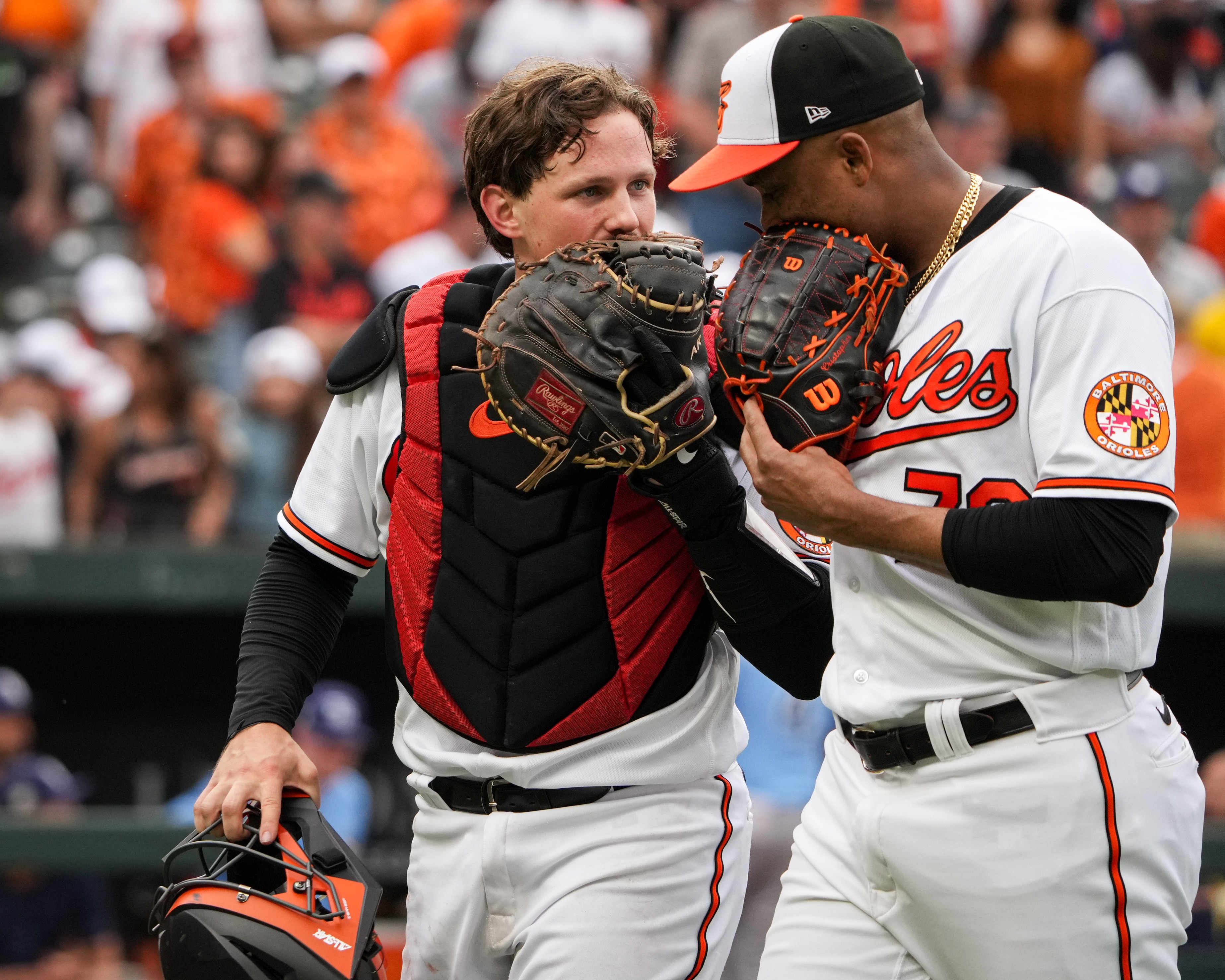 Orioles reliever Yennier Cano chats with catcher Adley Rutschman. Cano and the rest of the Orioles can use Monday's day off.