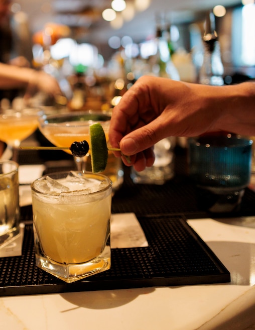 A staff member garnishes a cocktail at Seppia, a new restaurant in Hampden by the owners of La Cuchara.