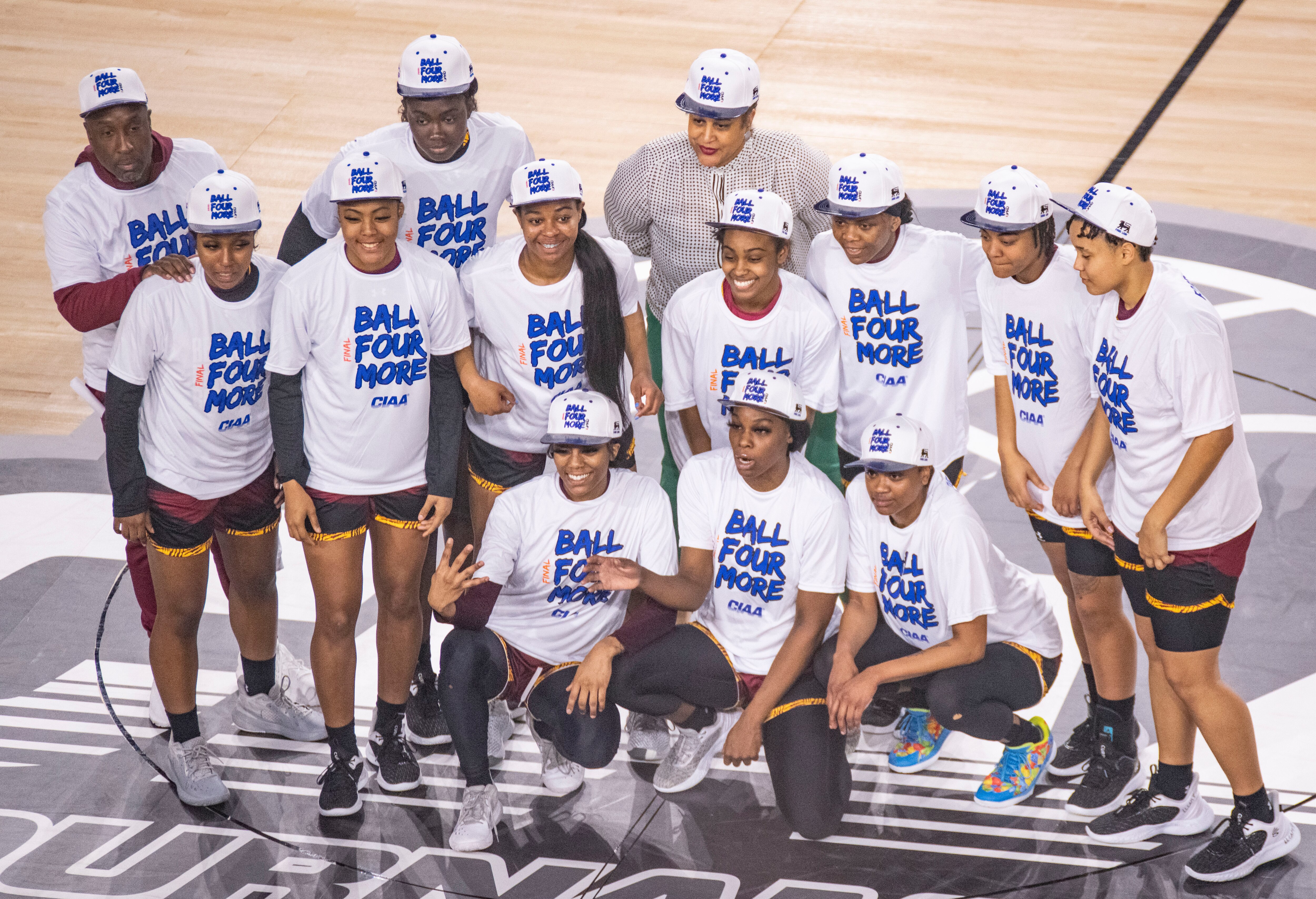 The Shaw University women gather for photos after beating Winston-Salem State game during the CIAA tournament at CFG Bank Arena last season.