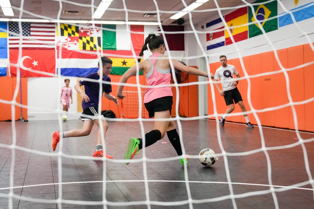 Mia Borkowicz, center, keeps the ball away from Matthew Weidman as Find Your Finesse founder Hendrik de Wit, right, observes his students at his futsal training center inside the Eastpoint Mall in Dundalk, Md. on Monday, August 17, 2026. The Eastpoint Mall is set to close at the end of August.