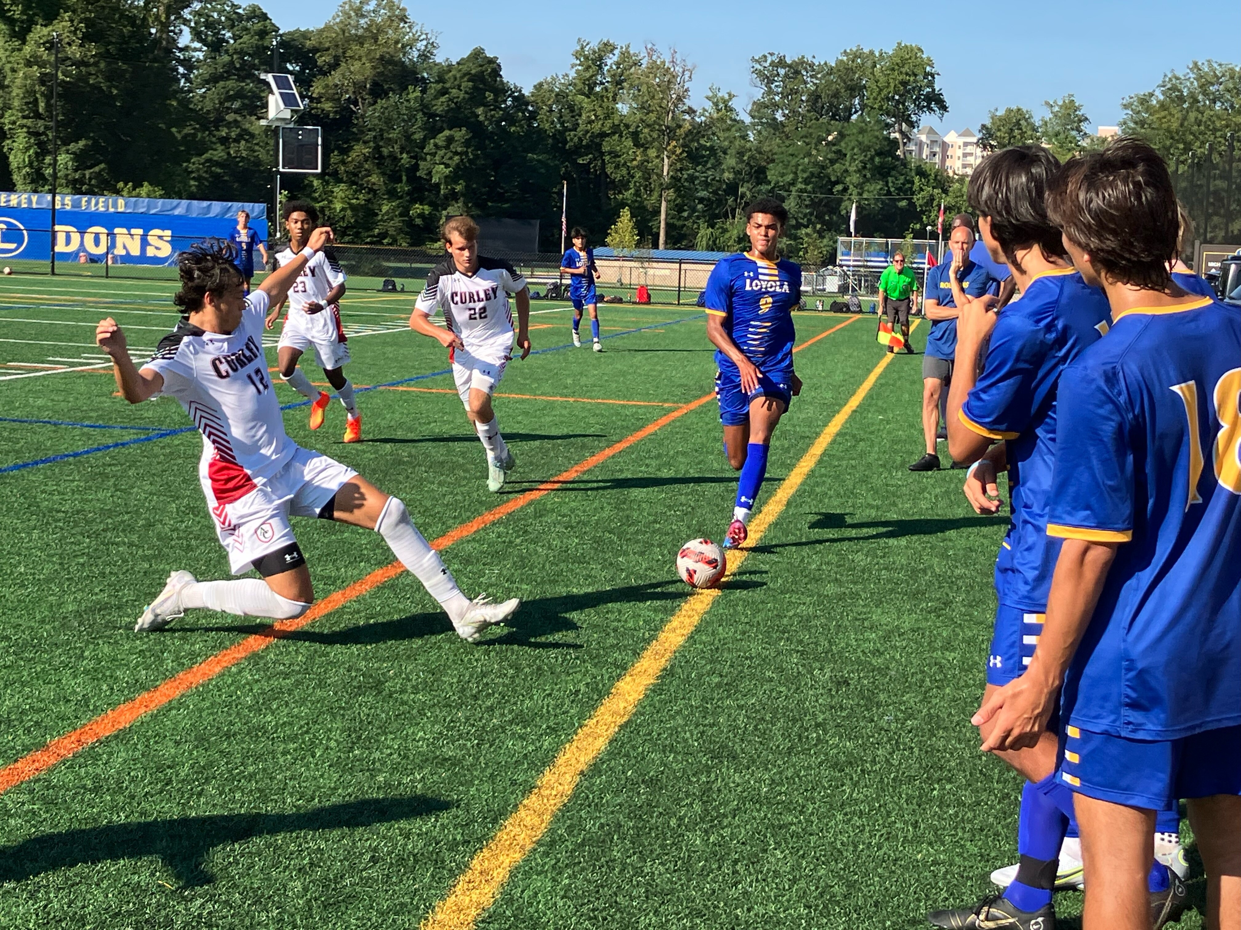 Archbishop Curley senior back Trey Magnaye (left) makes a sliding attempt to prevent Loyola Blakefield sophomore Sammie Walker from advancing toward goal as Friar teammate Mason Cook approaches. Curley beat the Dons, 3-0, on Wednesday afternoon.