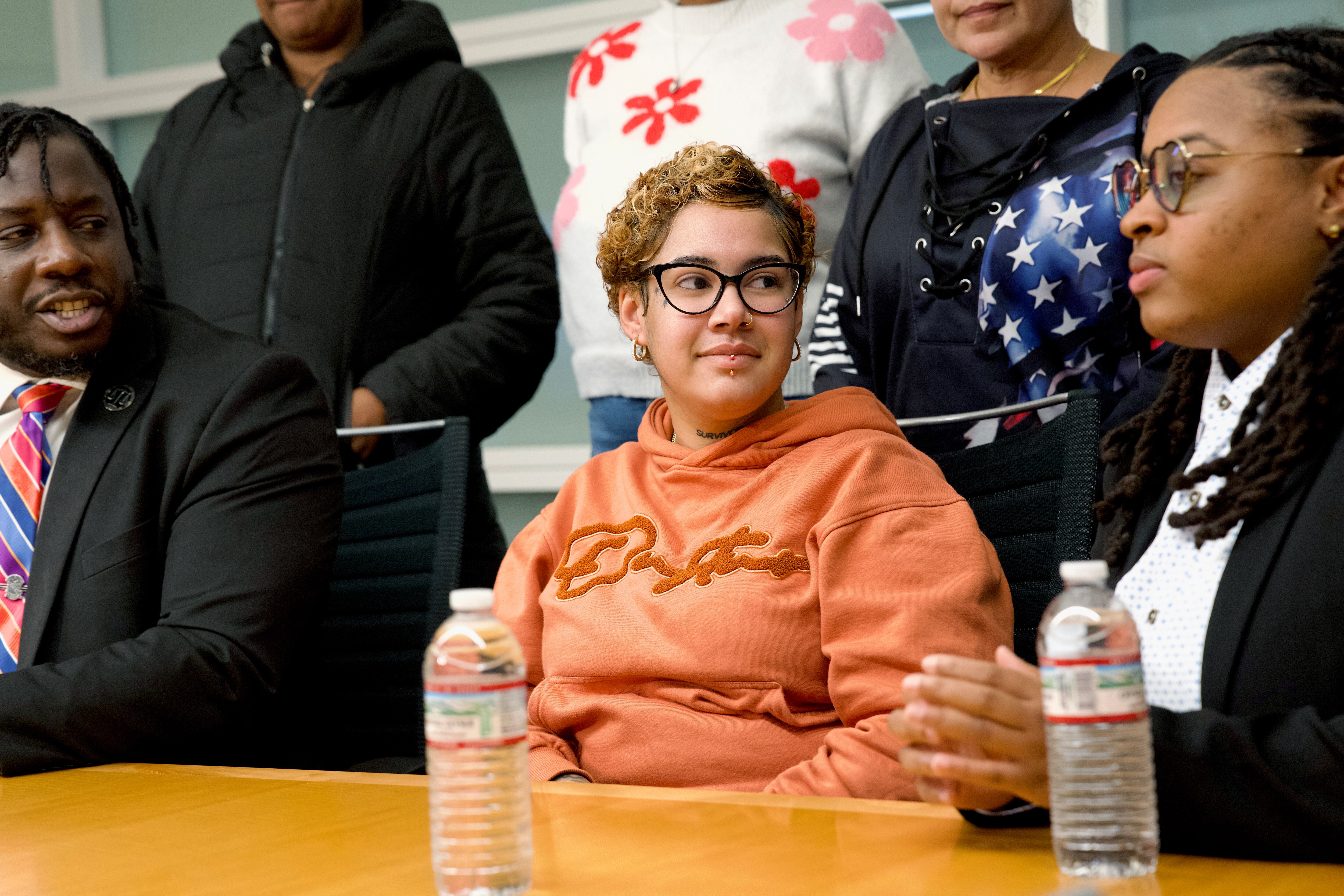 April Hurley, center, is joined by her attorneys Malcolm Ruff, left, and Phylecia Faublas, as well as her family at a press conference at the law offices of Murphy, Falcon & Murphy on Tuesday.