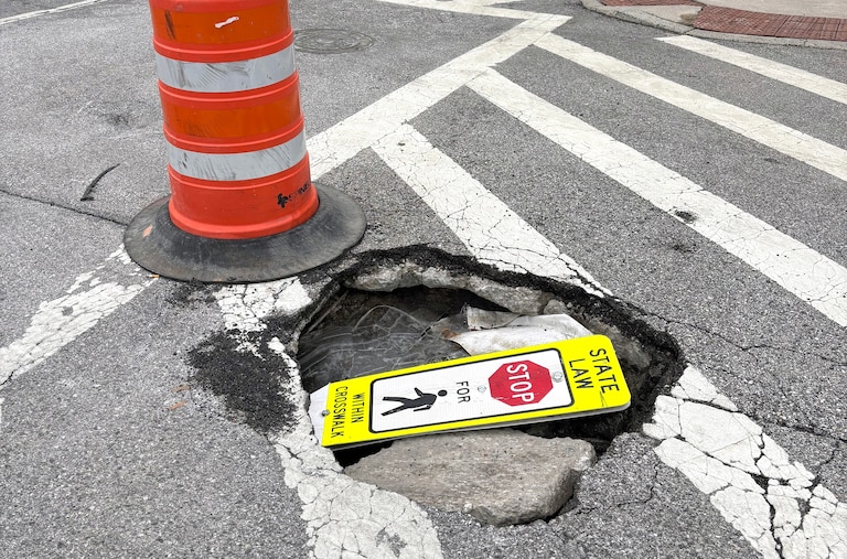 FEBRUARY 25, 2026 - A pedestrian sign was stuffed inside this Baltimore beauty at the intersection of Patterson Park Ave and Gough Street.