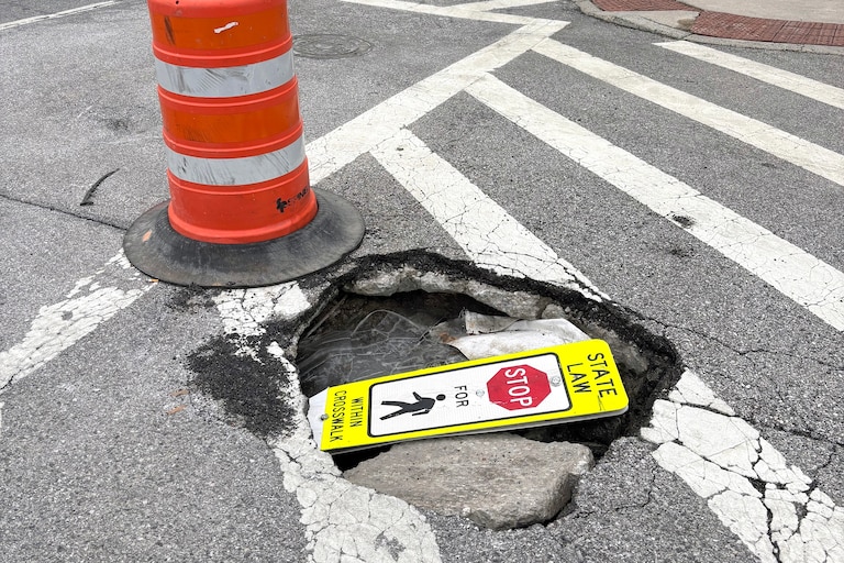FEBRUARY 25, 2026 - A pedestrian sign was stuffed inside this Baltimore beauty at the intersection of Patterson Park Ave and Gough Street.