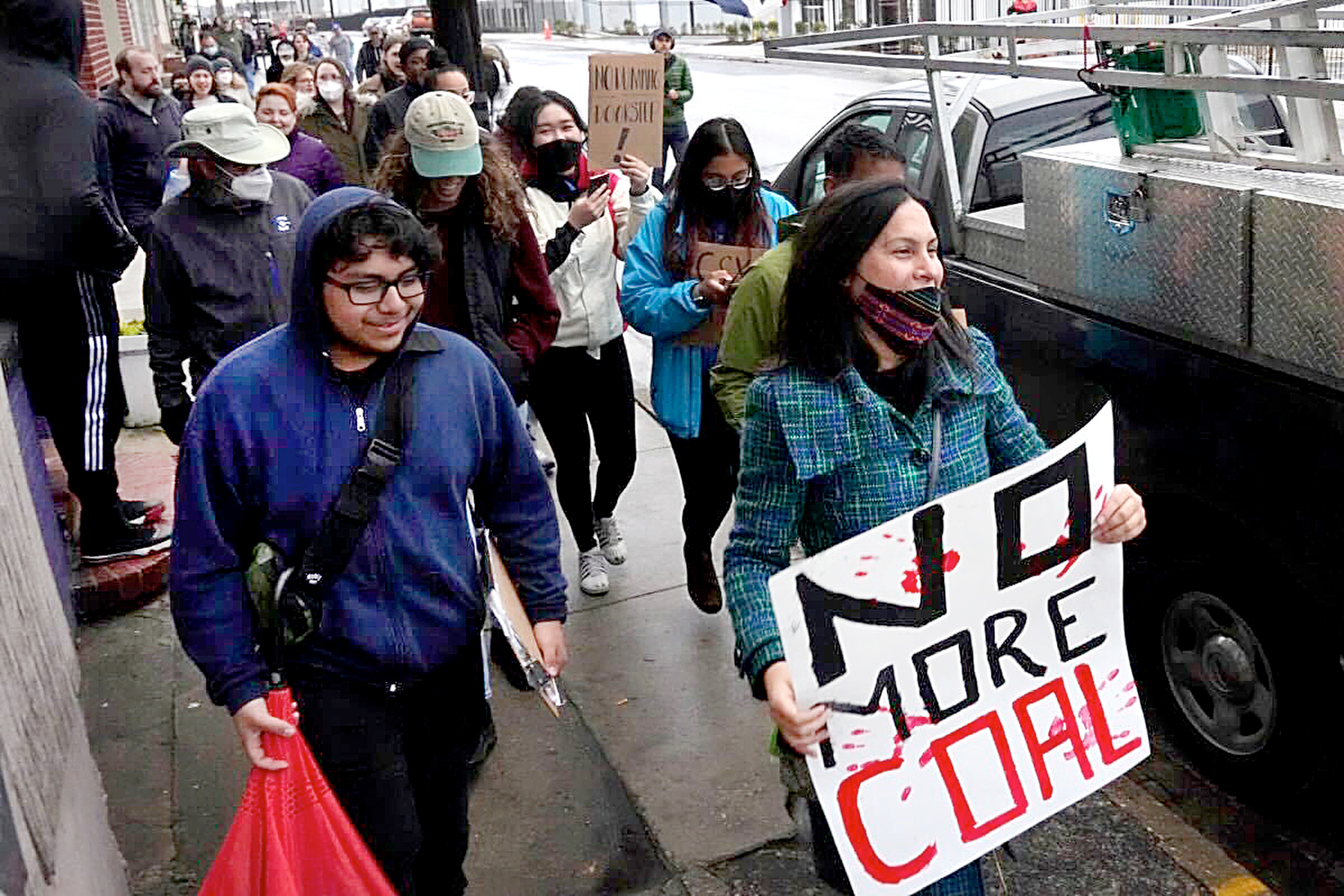 Protesters and activists march through Curtis Bay to the CSX facility on Wednesday.