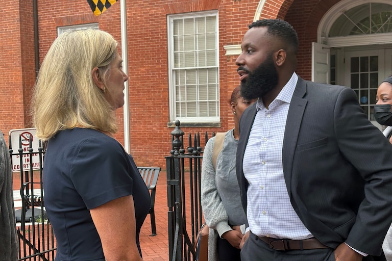 WEDNESDAY, SEPTEMBER 23, 2026 - Charles Blackeney, right, speaks with Anne Arundel County State's Attorney Anne Colt Leitess. Blackeney is the older brother of Britrain Gray, who was murdered while he was at work at a McDonald's in 2022.