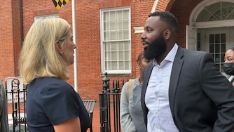 WEDNESDAY, SEPTEMBER 23, 2026 - Charles Blackeney, right, speaks with Anne Arundel County State's Attorney Anne Colt Leitess. Blackeney is the older brother of Britrain Gray, who was murdered while he was at work at a McDonald's in 2022.