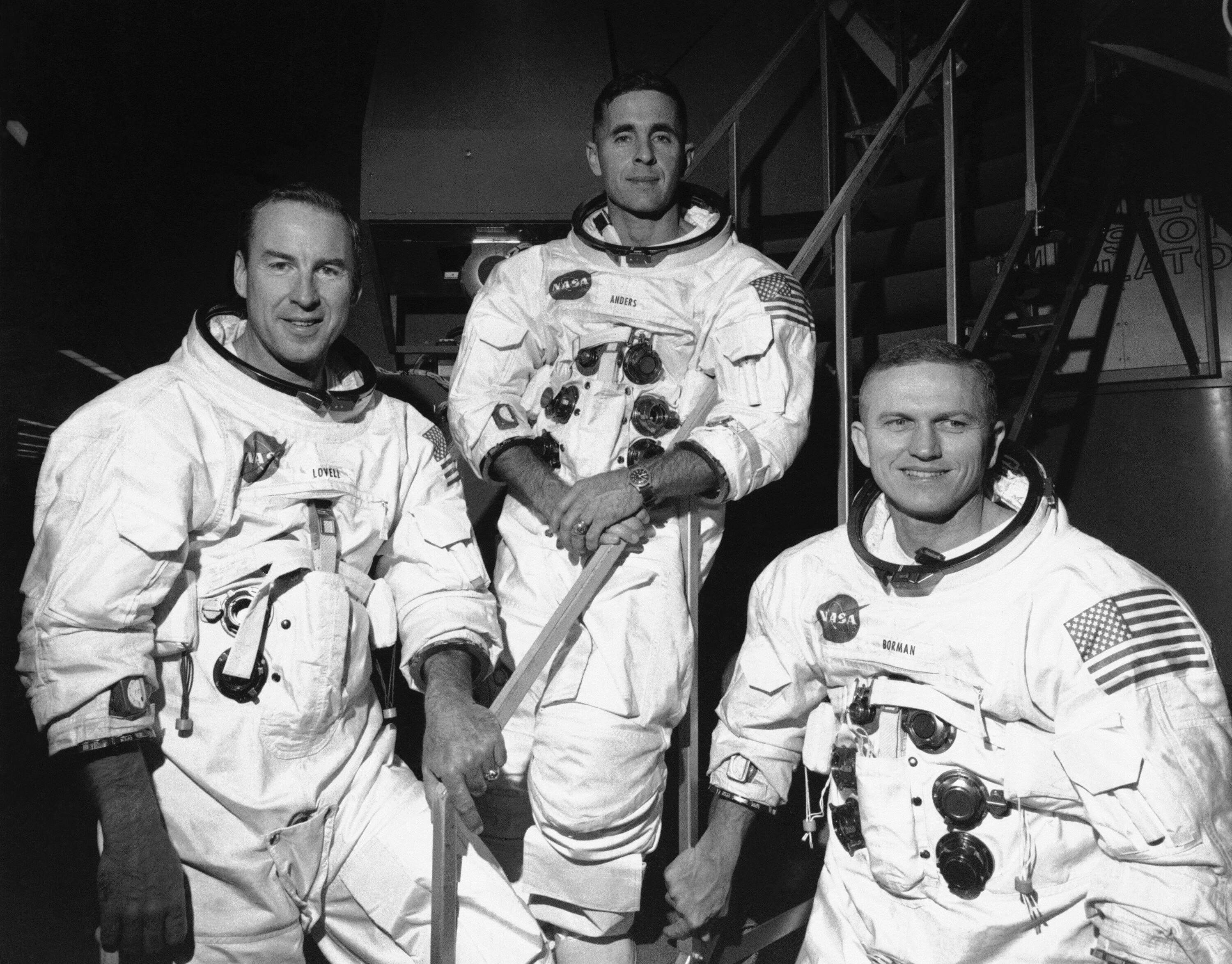 Apollo 8 astronauts, from left, James Lovell, command module pilot; William Anders, lunar module pilot; and Frank Borman, commander; stand in front of mission simulator prior to training in exercise for their scheduled six-day lunar orbital mission at the Kennedy Space Center in Florida, Dec. 18, 1968. Borman, who commanded Apollo 8's historic Christmas 1968 flight that circled the moon 10 times and paved the way for the lunar landing seven months later, has died. He was 95. Borman died Tuesday, Nov. 7, 2023, in Billings, Mont., according to a NASA statement Thursday, Nov. 9. (AP Photo/File)
