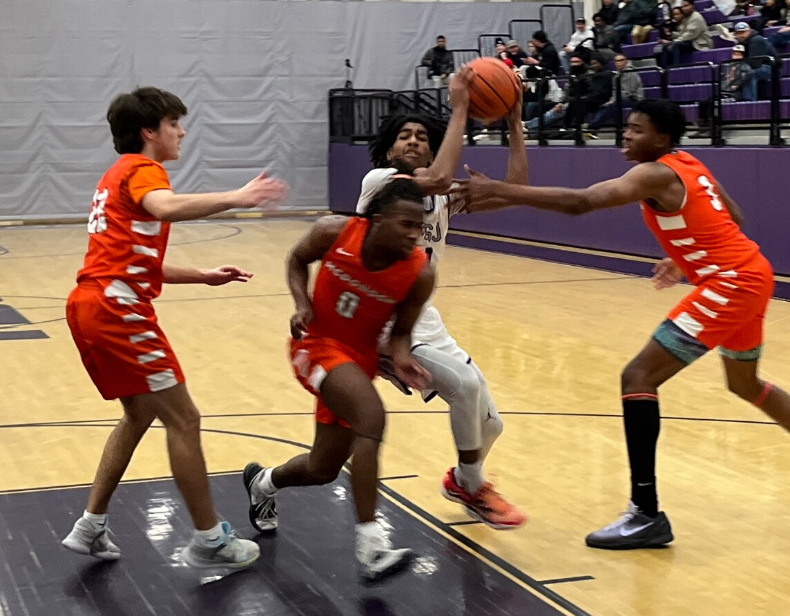 Mount St. Joseph's Ace Valentine (with ball) has McDonogh's Andrew Kasten (left), Mathani Paul-Swinson and Robby Fields defending as he drives to the basket during Monday's MIAA A Conference boys basketball contest. Valentine finished with 21 points and 10 rebounds, leading the No. 1 Gaels to a 92-60 win in Baltimore City.