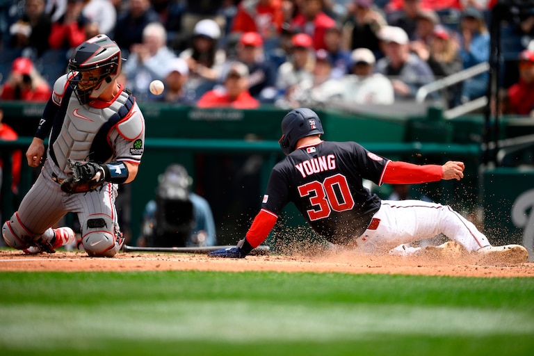 Washington Nationals center fielder Jacob Young slides home to score on a double by Keibert Ruiz in the third inning.