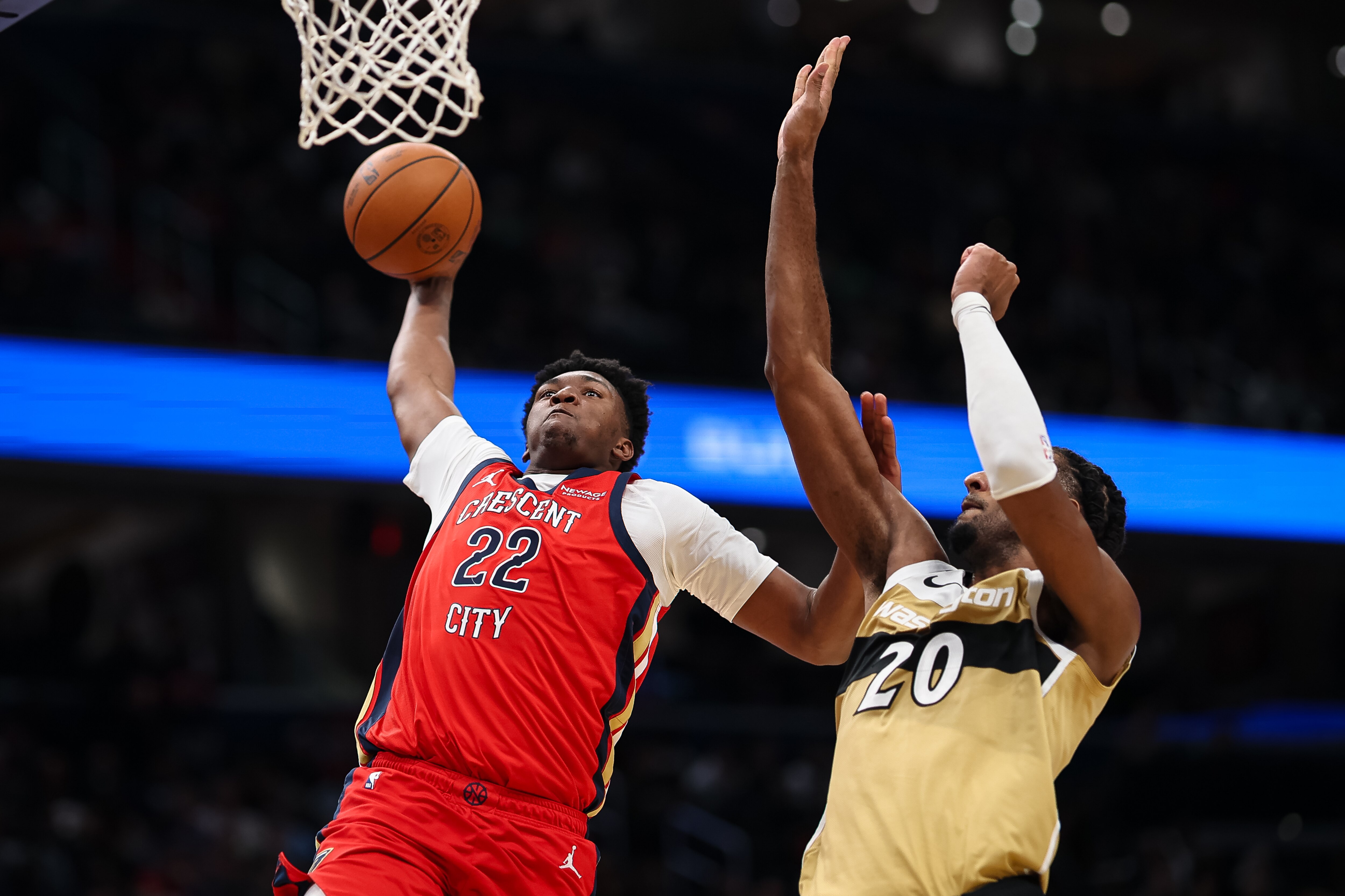 Derik Queen #22 of the New Orleans Pelicans goes to the basket against the Alex Sarr #20 of the Washington Wizards during the second half at Capital One Arena on January 9, 2026 in Washington, D.C.