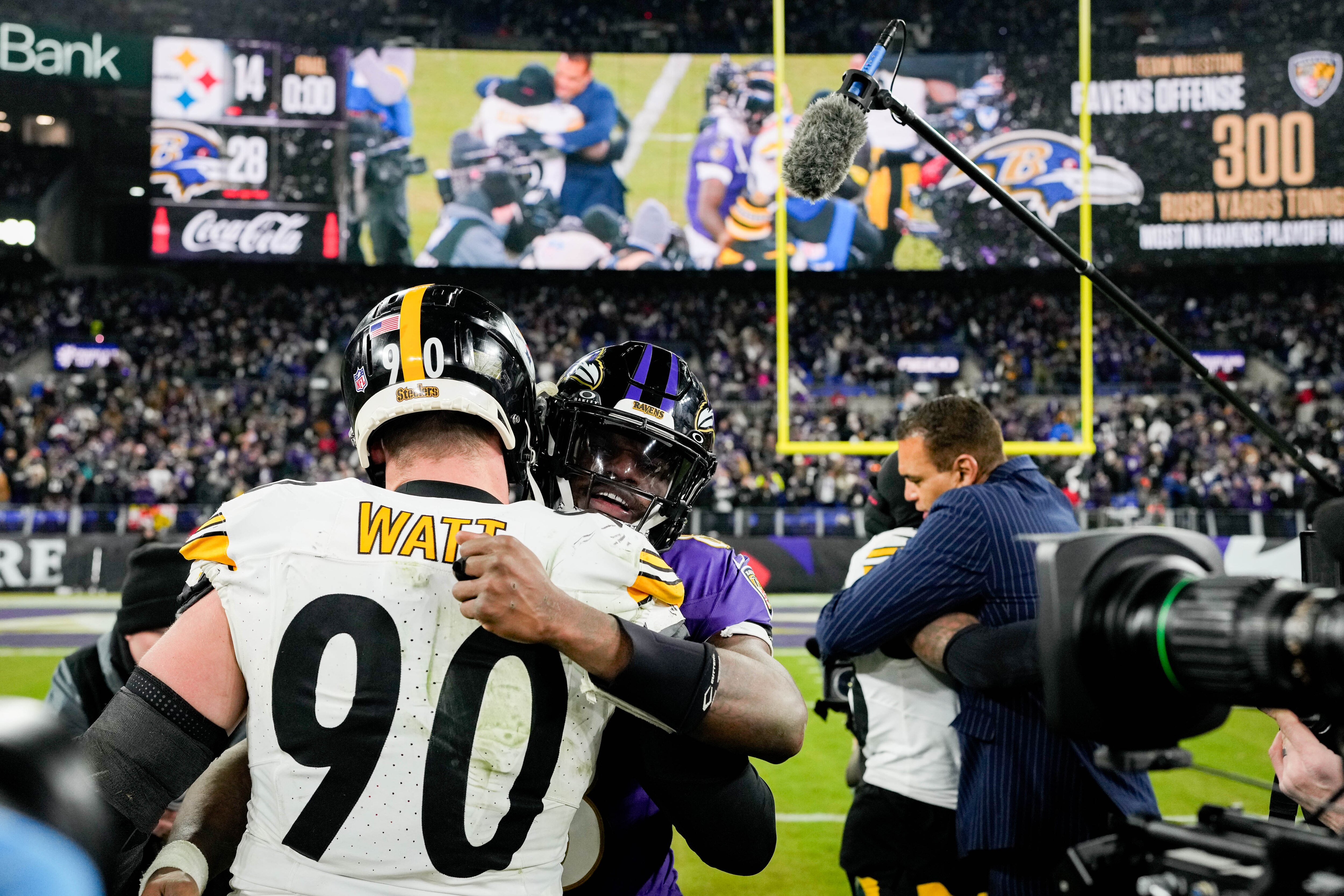 Ravens quarterback Lamar Jackson embraces Steelers linebacker T.J. Watt after Baltimore beat Pittsburgh in the playoffs last season.