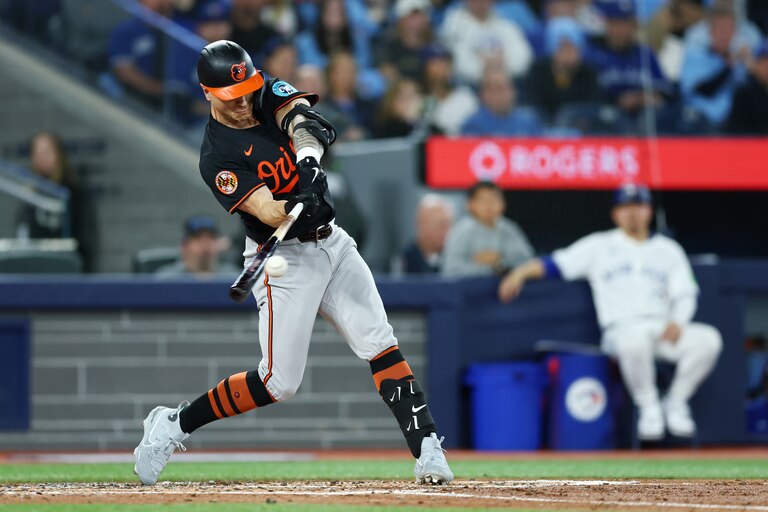 TORONTO, ONTARIO - MARCH 27: Tyler O'Neill #9 of the Baltimore Orioles hits a three-run home run against the Toronto Blue Jays during the third inning on Opening Day at Rogers Centre on March 27, 2025 in Toronto, Ontario.
