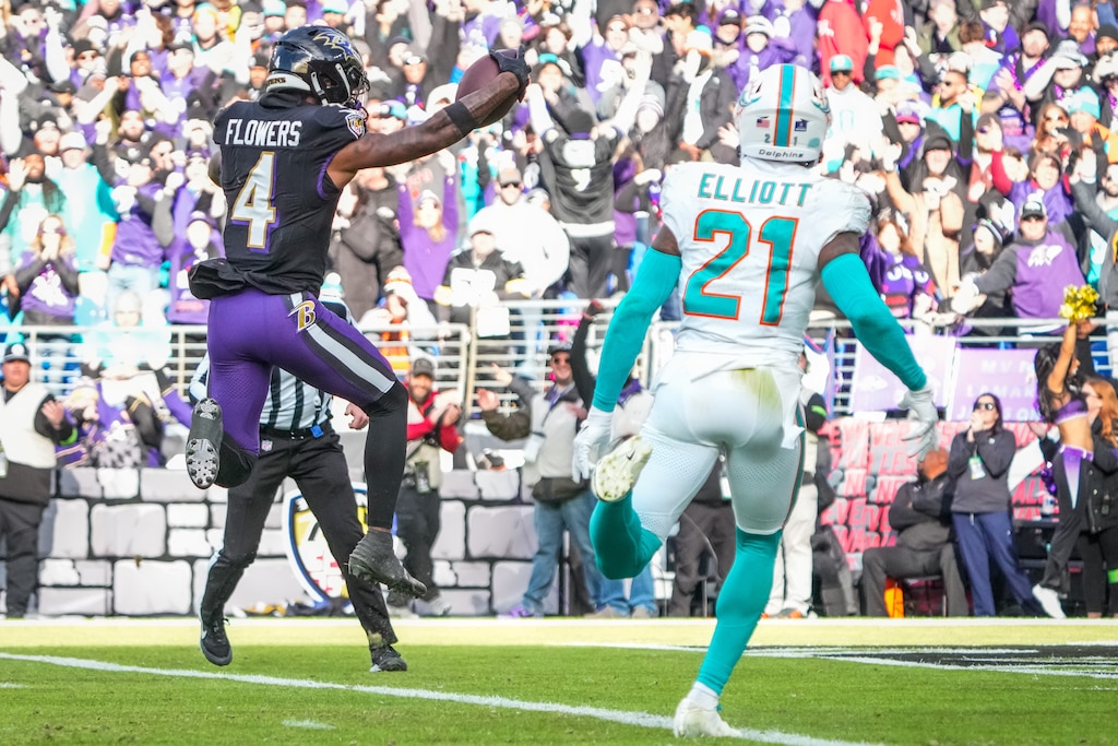 Baltimore Ravens wide receiver Zay Flowers (4) jumps into the end zone to score a touchdown during the second quarter against the Miami Dolphins at M&T Bank Stadium on Sunday, Dec. 31, 2023.