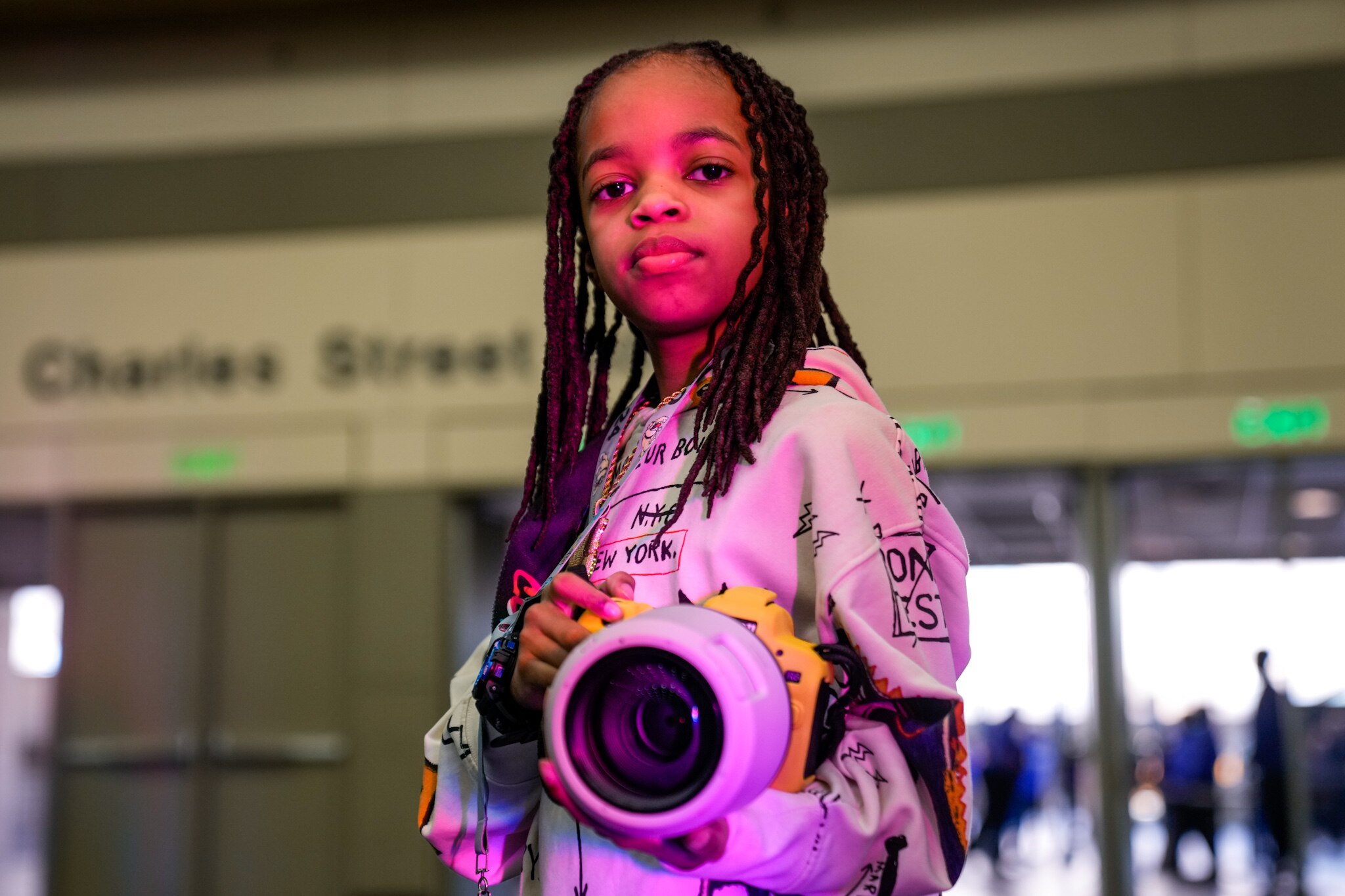 Myles Minishotta, a young photographer who has been covering the CIAA tournament this year, poses for a portrait at Fan Fest in the Baltimore Convention Center on Friday, March 1, 2024.