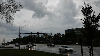 Cars drive on West Nursery Road near BWI during a thunderstorm in the Baltimore, Md. region on Tuesday, July 1, 2025.
