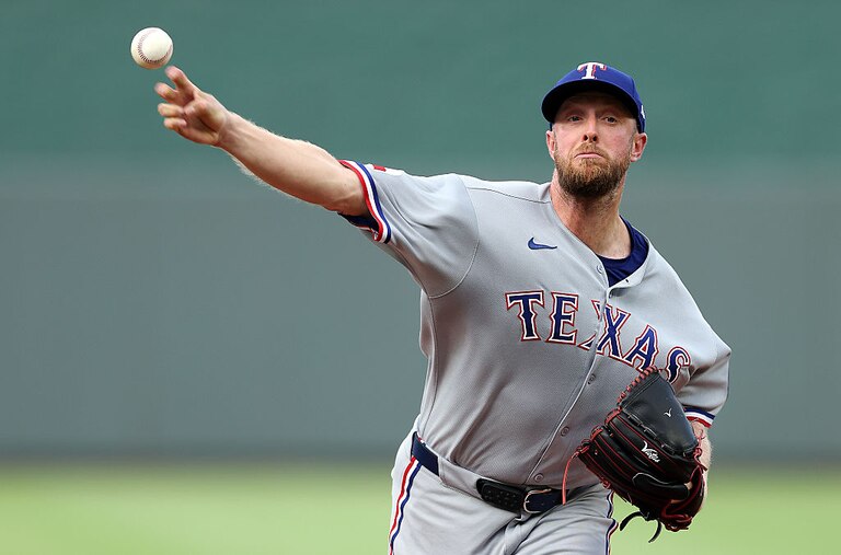 Merrill Kelly warms up prior to the Texas Rangers' game against the Kansas City Royals on Aug. 19.