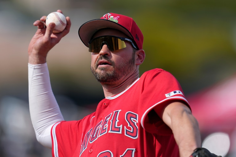 Los Angeles Angels first baseman Trey Mancini tosses a baseball into the crowd during the fourth inning of a spring training game.