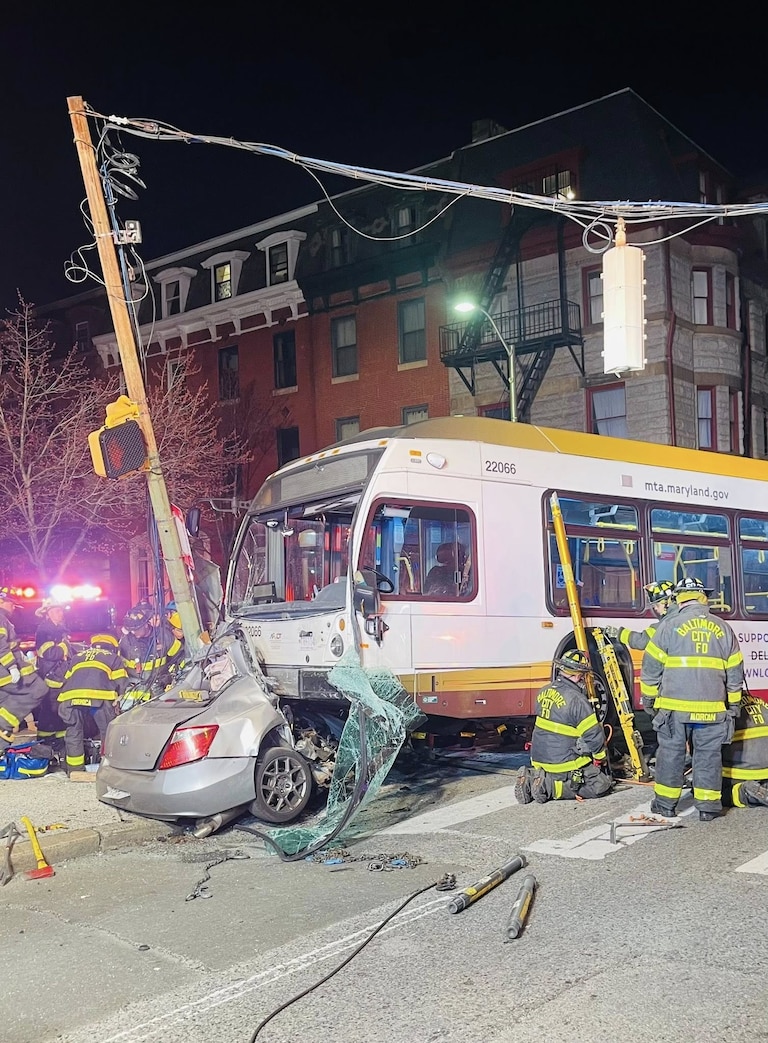 Baltimore City firefighters respond to a collision involving two cars and an MTA bus.