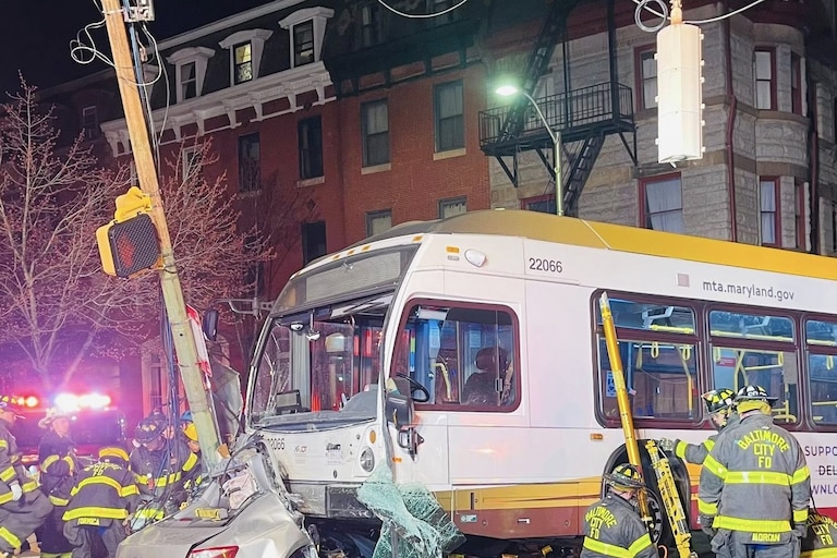 Baltimore City firefighters respond to a collision involving two cars and an MTA bus.