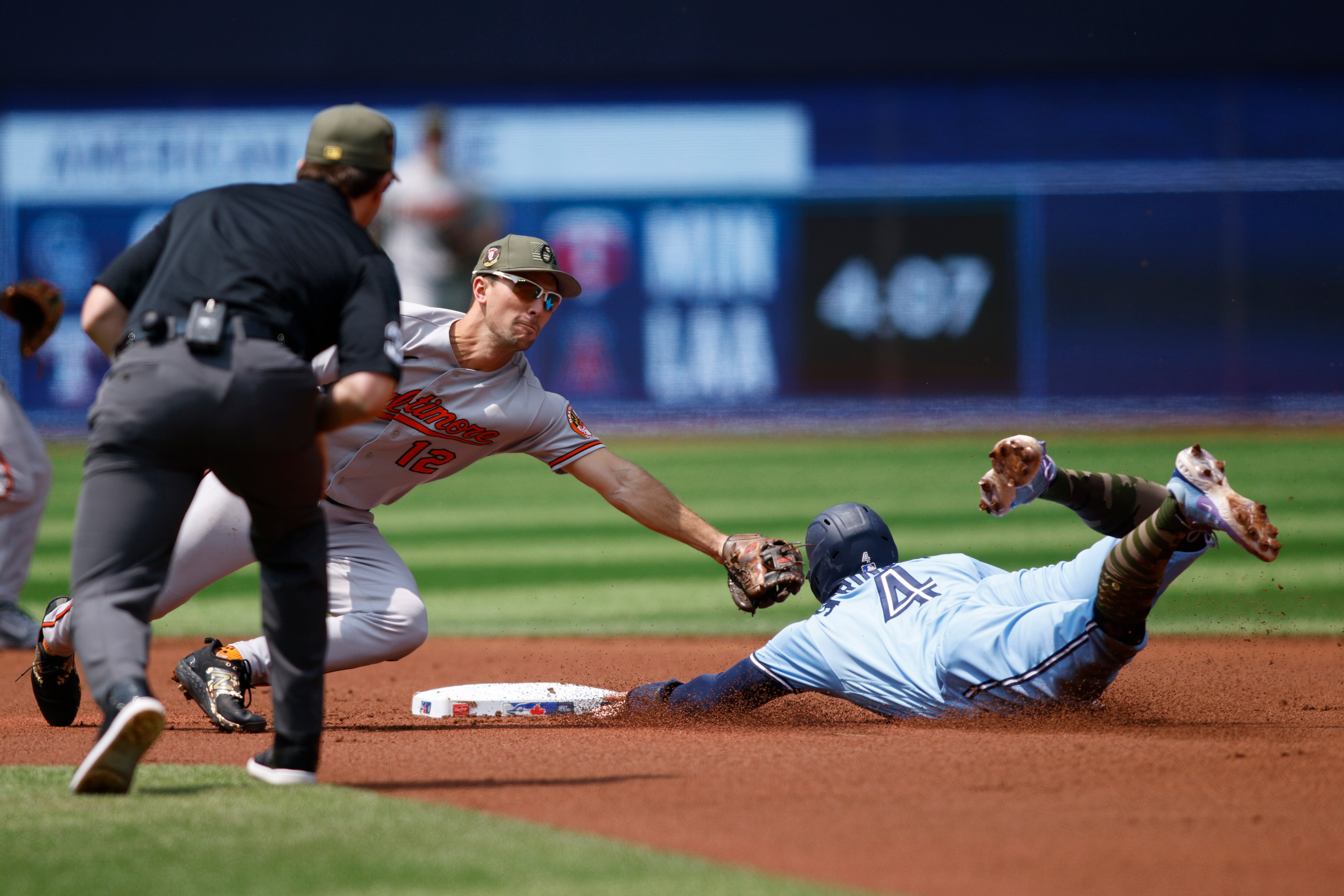 George Springer #4 of the Toronto Blue Jays steals second base from Adam Frazier #12 of the Baltimore Orioles in the first inning of their MLB game at Rogers Centre on May 21, 2023 in Toronto, Canada.