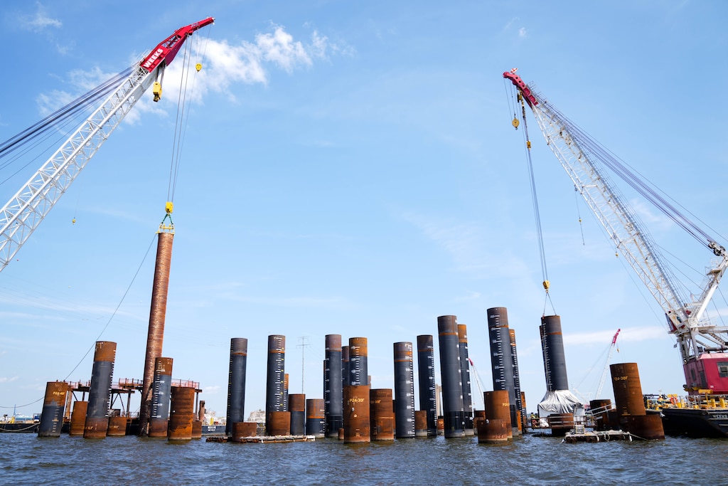 Piles are lifted by crane into the water next to an older section of the Francis Scott Key Bridge in Baltimore, Md. on Wednesday, August 26, 2026.