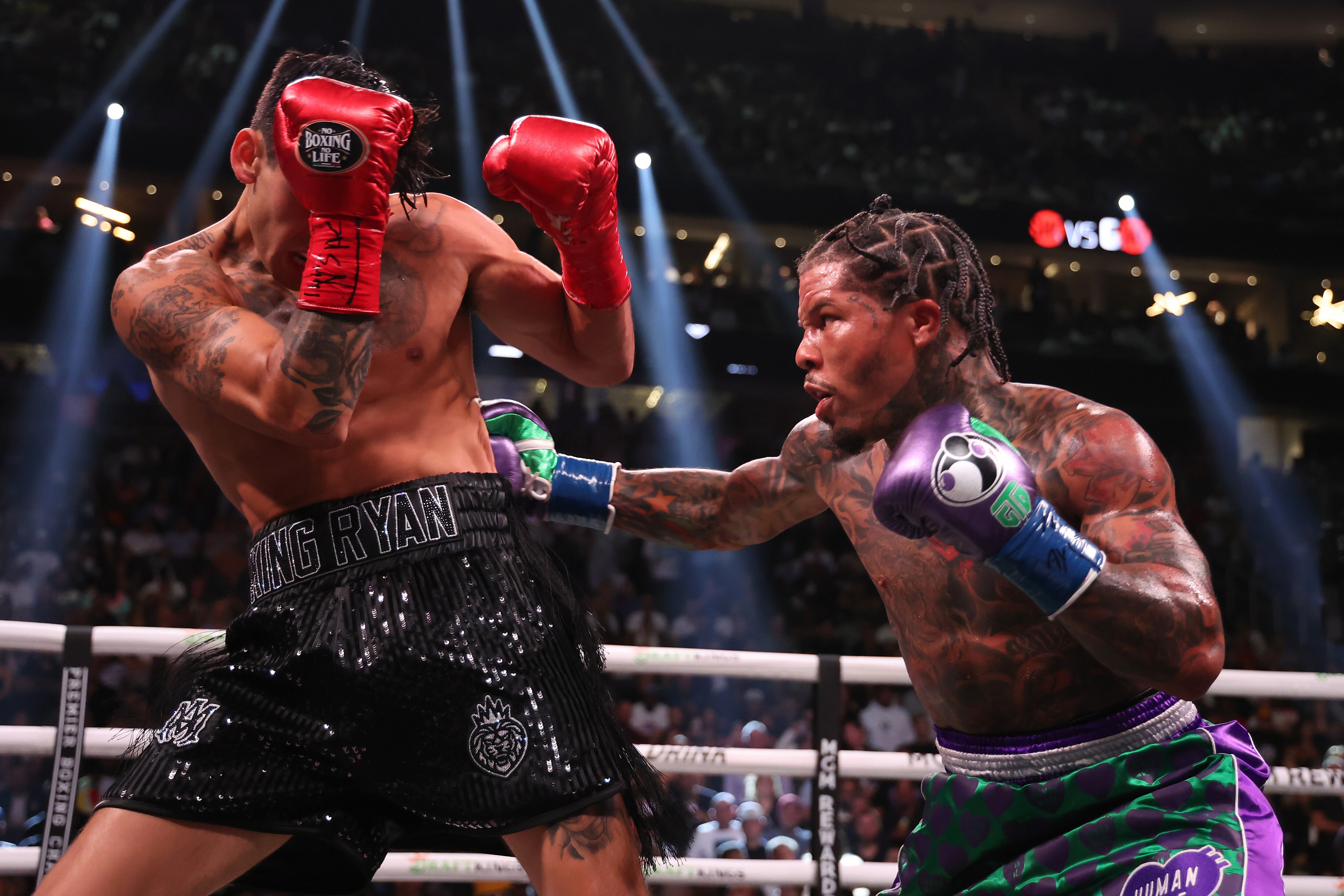 Gervonta Davis in the green and purple trunks punches Ryan Garcia in the black trunks during their catchweight bout at T-Mobile Arena on April 22, 2023 in Las Vegas, Nevada.