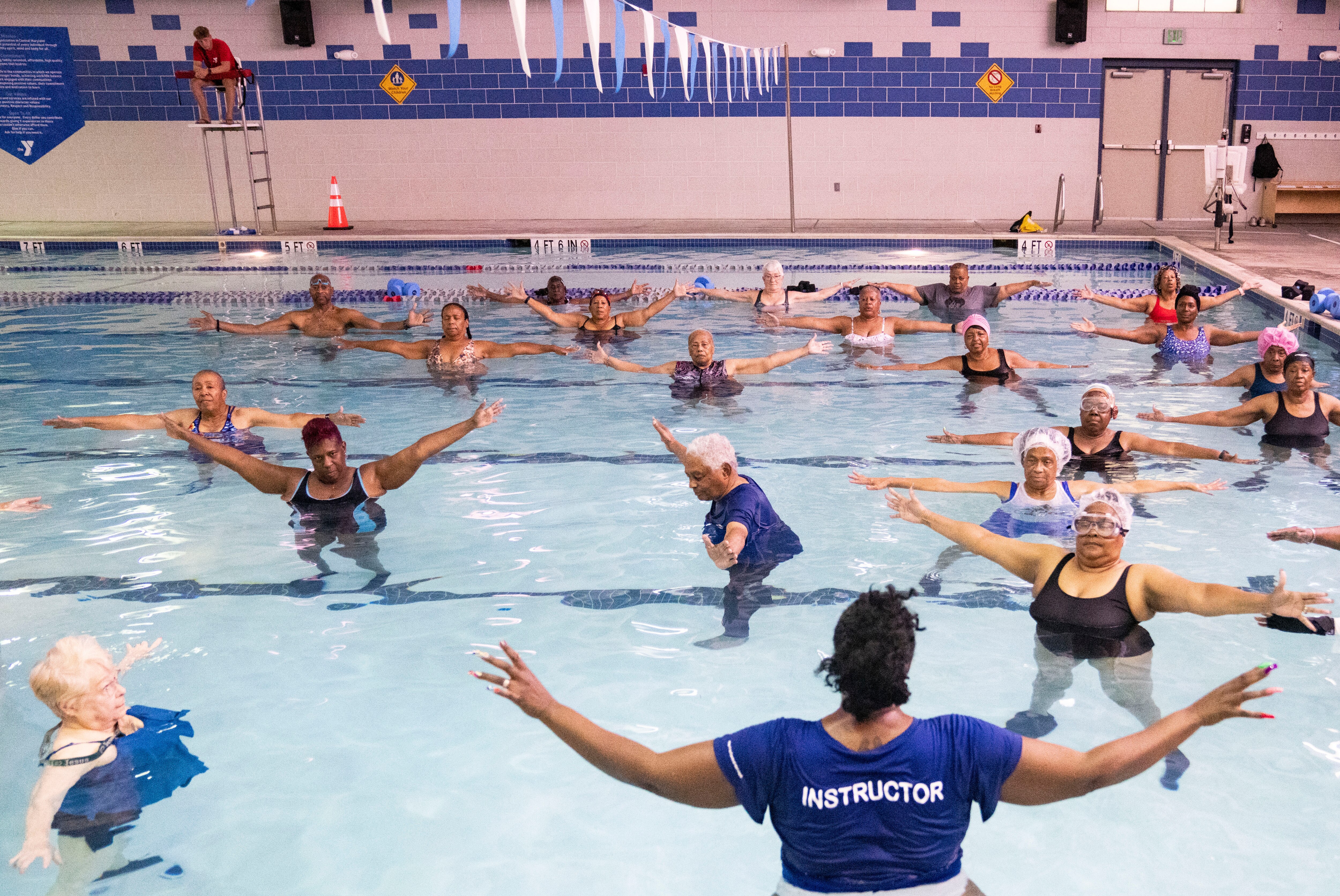 Alysha Lea water fitness instructor leads a class of people  at the Y Swim in Randallstown, Tuesday, September 9, 2025.