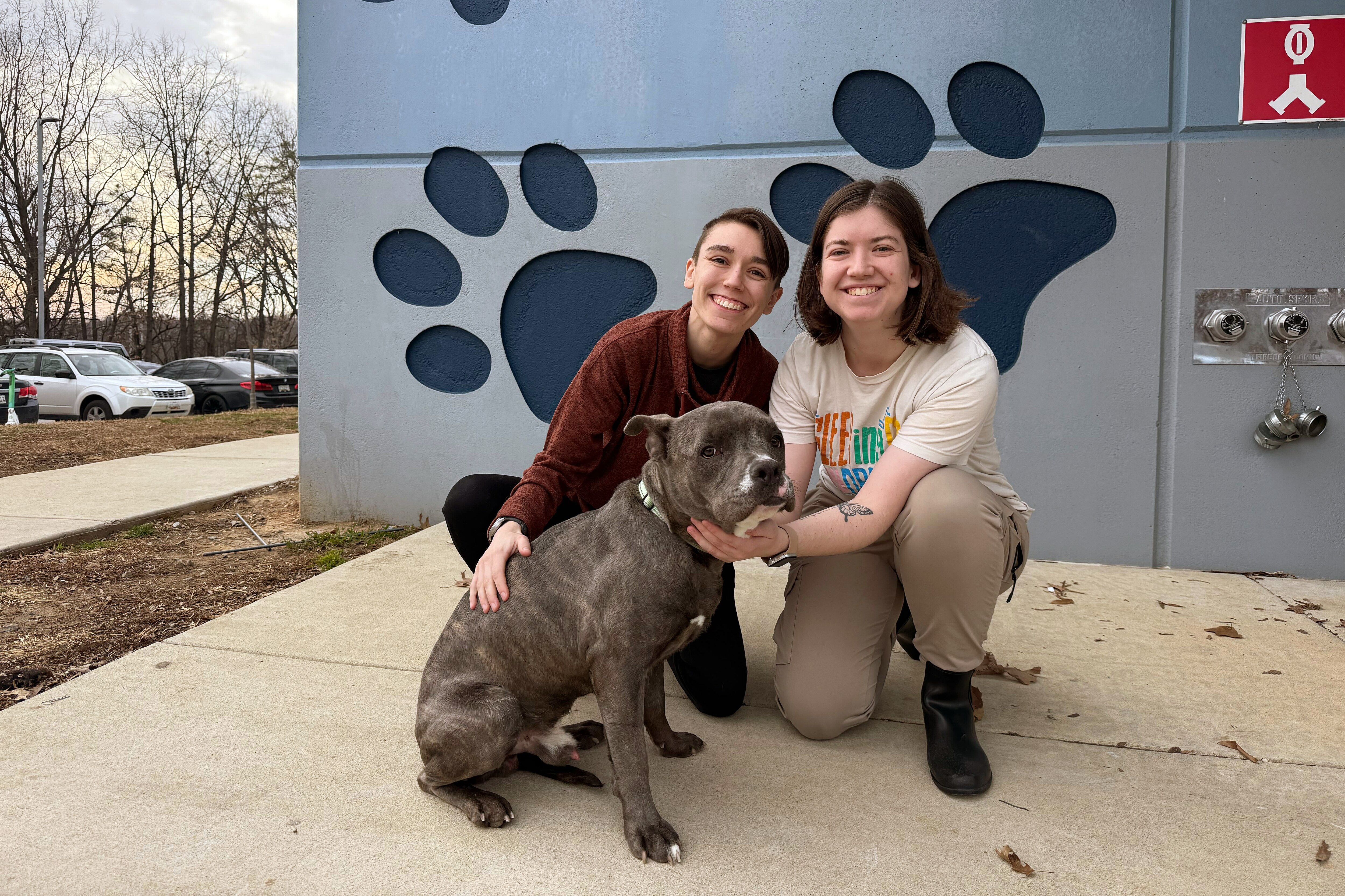 Sierra Gold (left) and Shelby Gold (right) with their part-pitbull pup, Cheeto Burrito, outside of Baltimore Animal Rescue and Care Shelter (BARCS) on Thursday afternoon.