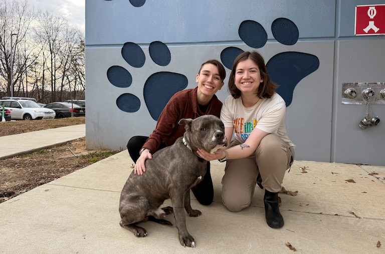 Sierra Gold (left) and Shelby Gold (right) with their part-pitbull pup, Cheeto Burrito, outside of Baltimore Animal Rescue and Care Shelter (BARCS) on Thursday afternoon.