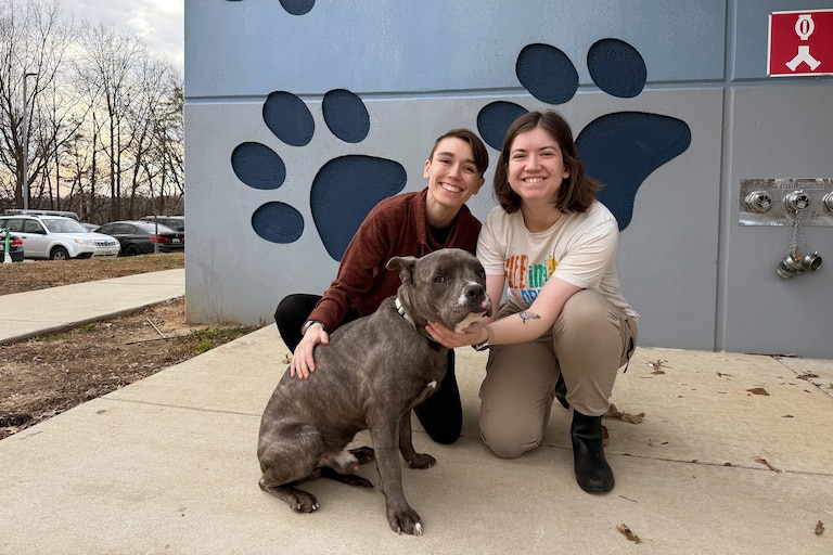 Sierra Gold (left) and Shelby Gold (right) with their part-pitbull pup, Cheeto Burrito, outside of Baltimore Animal Rescue and Care Shelter (BARCS) on Thursday afternoon.