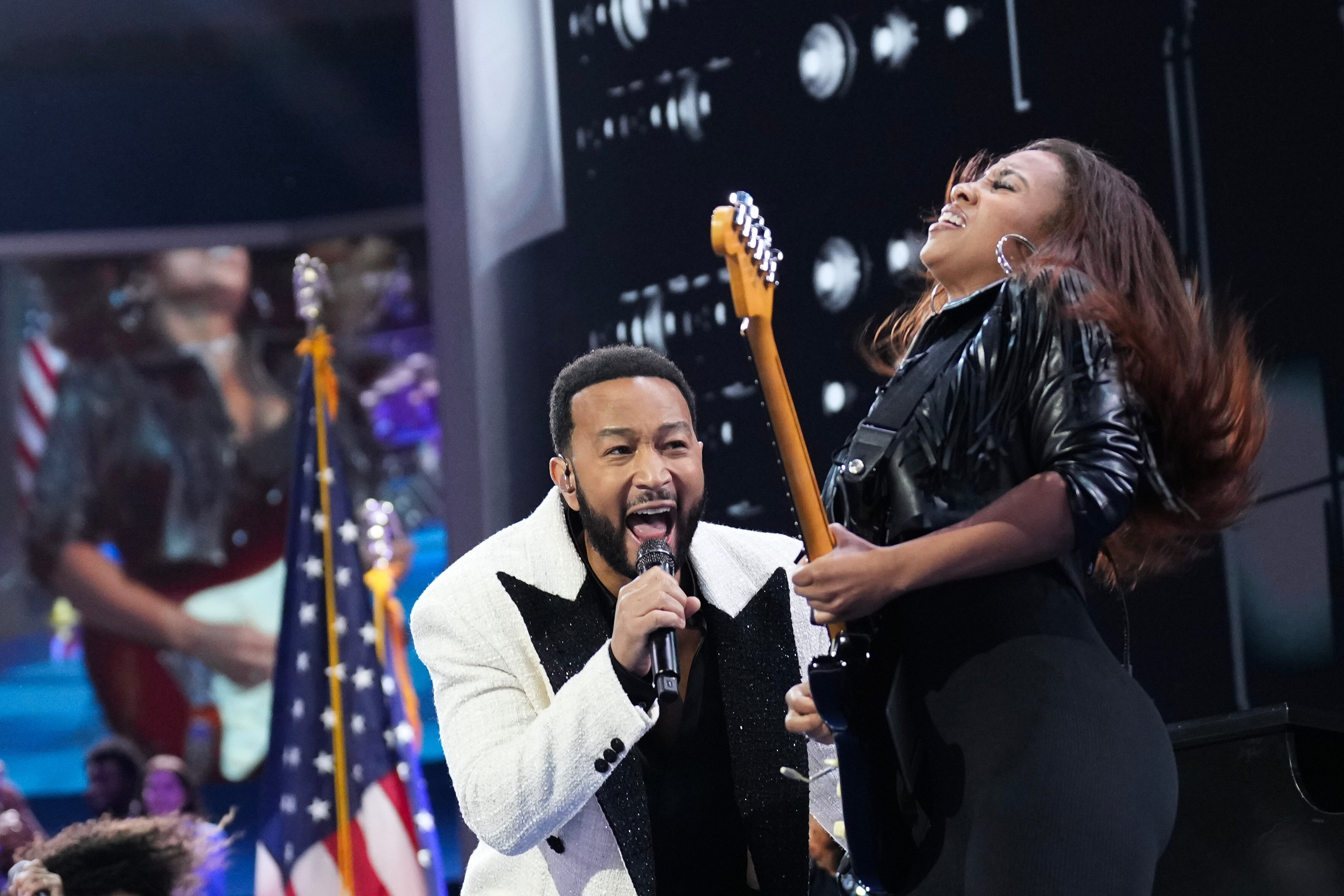 Ariel “Ari” O'Neal, right, performs alongside John Legend during the Democratic National Convention in Chicago on Aug. 21.