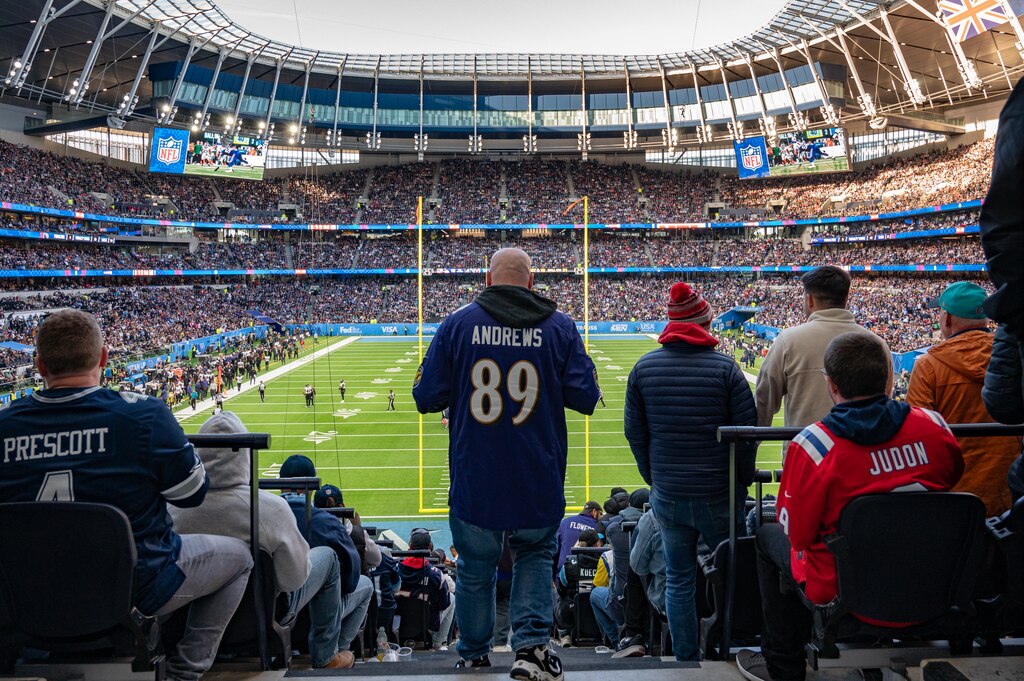 A ravens fan returns to his seat to watch the final quarter of the Ravens and Titains game in Tottenham Hotspur Stadium for the game on Oct. 15, 2023.